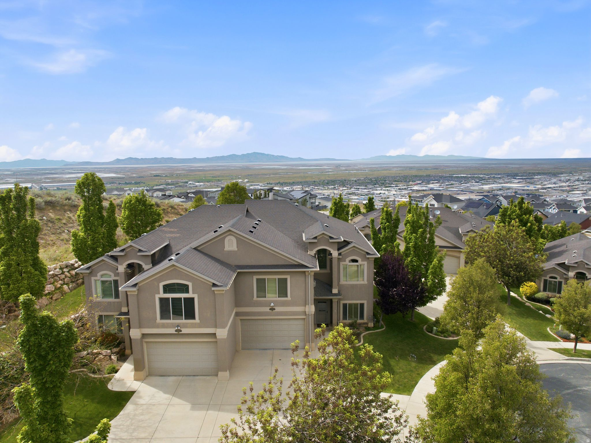Rare Edgewood Estates townhome offering 3,451 sq ft, two complete above-grade living areas, two kitchens, elevator access, and beautiful sunset views from both the covered deck and covered patio. Designed for flexible living, 202 Edgewood Cir is ideal for multigenerational households, guests, professionals, or anyone seeking stair-free convenience just 15 minutes from downtown Salt Lake City and the international airport.The upper level features a large kitchen, dining and great room area. There is a great built-in desk in the great room upstairs.   A spacious primary suite along with a second bedroom.  The lower level has a full kitchen, family room, 2 bedrooms, a full bathroom, laundry and a living room.  All of this unit is above grade so there are no windows.   Beautiful sunset views out the back of the unit from your covered deck and covered patio, Stainless steel appliances, granite countertops, real hardwood floors, plantation shutters vaulted ceilings. rollout shelves in kitchen. Quiet cul de sac location.