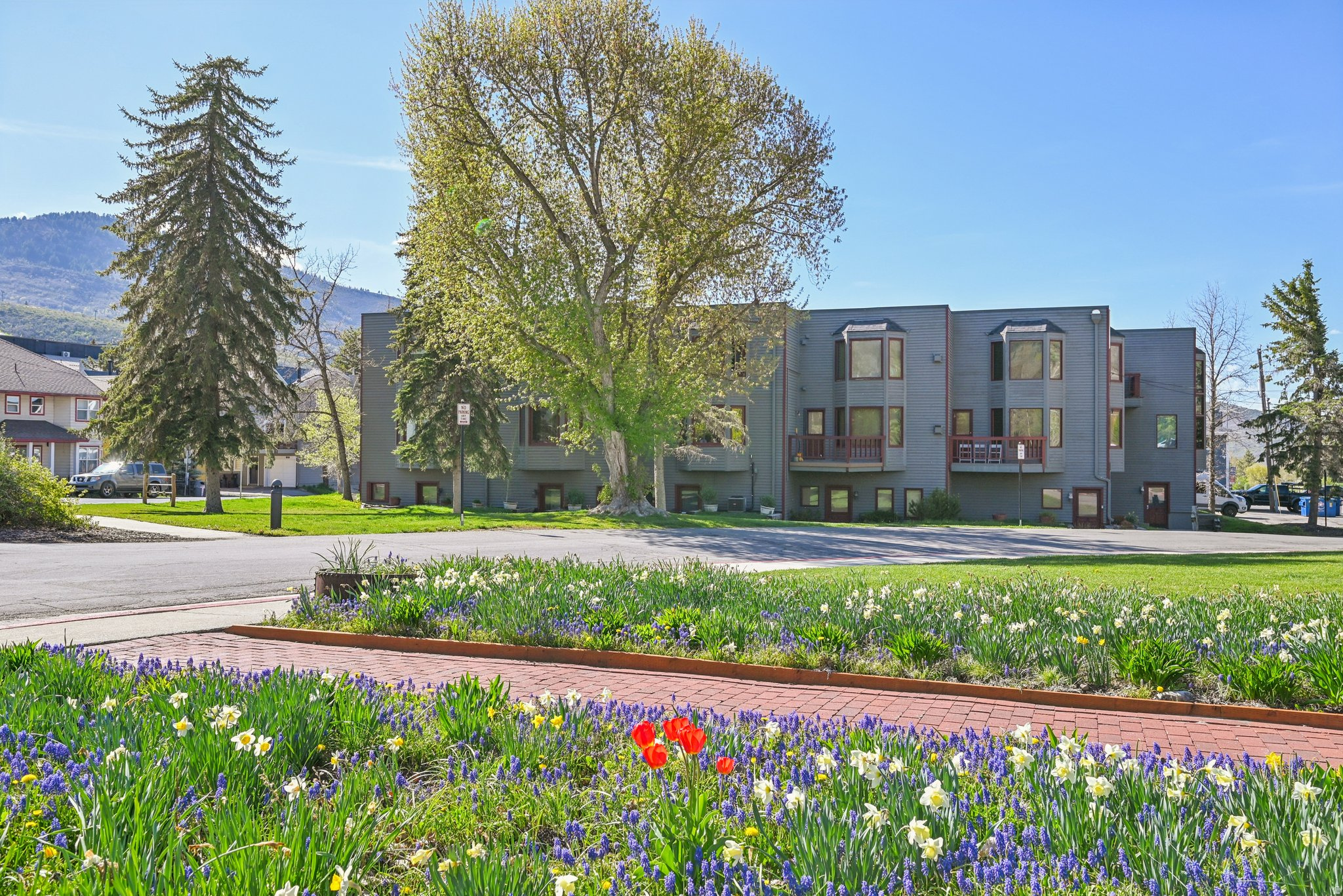 This spacious townhome at 1378 Park Avenue offers an incredible location in the heart of Park City. It sits adjacent to the historic Miners Hospital at the entrance to City Park, home to grassy fields, tennis & basketball courts, a playground, sand volleyball courts, and a skate park. Enjoy walkability to Historic Main Street, slopes of Park City Mountain Resort, bike/hike trails, shopping, dining, and events, plus direct access to Park City's free transit route for easy transportation year-round. The home features beautiful ski resort views and is part of a small, well-maintained community of just eight residences. Owners and guests share access to a spacious deck with a large hot tub, perfect for aprs-ski relaxation or summer evenings. Inside, the traditional layout includes defined living areas and timeless, well-kept finishes. A private in-unit sauna adds a cozy and desirable amenity, ideal for unwinding after a day on the mountain. Additional highlights include generous storage space and a dedicated parking spot in a secure community garage. This property is in a premier spot along Park City's popular Fourth of July Parade route, it is an exceptional opportunity for short-term rental income, a seasonal retreat, or long-term family asset.