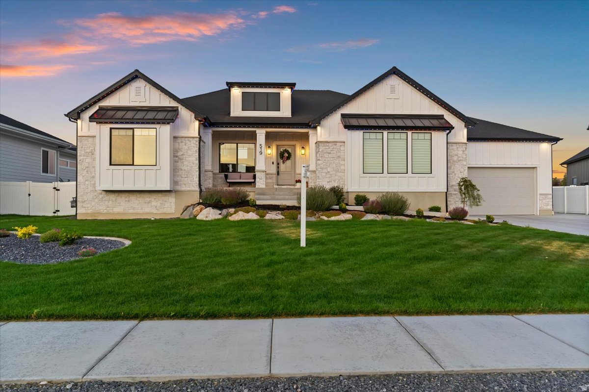 Welcome to this beautifully upgraded modern farmhouse in West Point with nearly 4,000 sq ft of living space and breathtaking mountain views! Soaring 12' ceilings in the entry and great room set an impressive tone throughout. The gourmet kitchen features a 36" gas cooktop, double ovens, farmhouse apron sink, custom cabinetry, tile backsplash, oversized knotty alder island and quartz counters throughout. The primary suite offers a tray ceiling, barn door, split dual vanities, walk-in shower w/bench and spacious WIC. The fully finished walkout basement includes a large rec room, dry bar/kitchenette, 3 bedrooms and 1 bathroom. Enjoy unobstructed mountain views from the covered Trex deck. Extras: Glow programmable lighting, battery-powered shades on the main floor, pre-wired hot tub disconnect, huge 3-car garage, RV pad, storage shed, built-in mudroom bench and cubbies and a fully landscaped and meticulously maintained yard with vinyl-fenced backyard. 5 bed | 3 bath | ~4,000 sq ft. Better than new!
