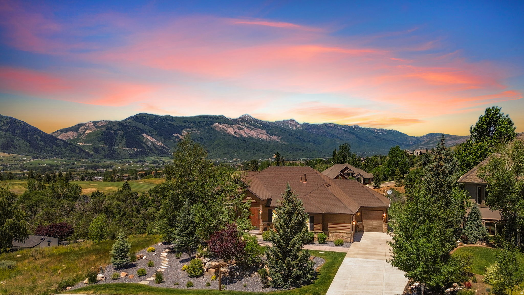 Situated on the coveted Elkhorn neighborhood hillside, welcome to the home buyers spend years searching for. This custom mountain residence captures panoramic views of Pineview Reservoir, the peaks of Snowbasin, Nordic Valley, and the Ogden Valley floor. Nearly every angle of the home is oriented toward a breathtaking backdrop, with protected space behind the property that preserves privacy and views. The backyard has a seasonal stream, and is professionally landscaped with mature trees. The secluded patio comes with private hot tub to unwind after a long day on the mountain. Step inside and you'll immediately find high-end design with excellent mountain views that span from the living area to the kitchen. High-vaulted ceilings give the home a spacious feel and newly installed LED lighting, along with plenty of natural light, create an extremely warm atmosphere. Other high-end finishes includ granite countertops, hardwood floors, double ovens, and a walkout lower level with high ceilings. The home features fireplaces in the upstairs and downstairs living areas, as well as in the spacious master bedroom. On the lower level, you'll find a custom sauna, an additional kitchen for guests and entertaining, and four large bedrooms. The home was built with a massive garage big enough to fit four cars, as well as an additional RV pad for boats, trailers, and more. Because the home is not in an HOA, there are no rules restricting outside parking. The home is also equipped with a smart thermostat, double pane windows with brand new window screens, window coverings, and more! The home is in the center of the Wolf Creek Resort area, and is centrally located to all the Ogden Valley has to offer. Homes of this size and location are hard to come by. Schedule a private showing today!