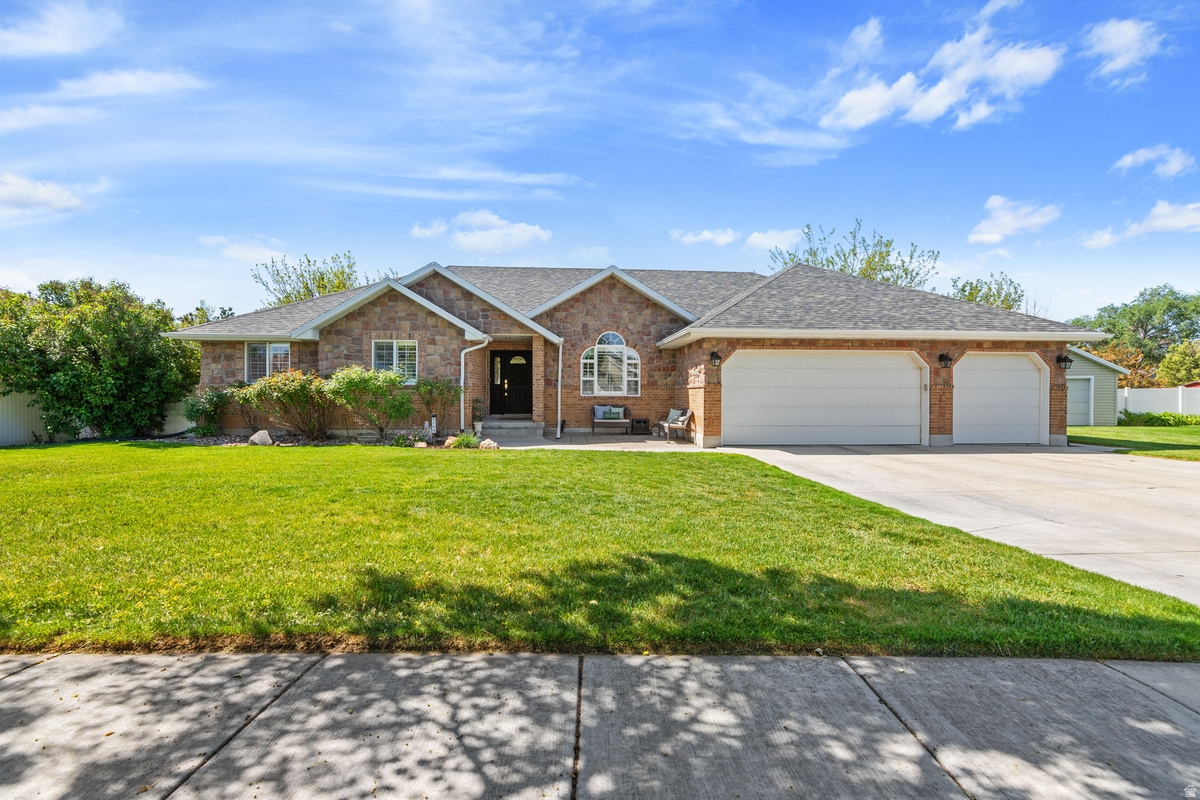 Beautiful updated home in Riverton tucked away on a rare half acre lot.  This custom home offers quality, beauty, and functionality.  Boasting six spacious bedrooms with ample closet space in each one and four bathrooms.  There is plenty of space to spread out and relax.  The great room is bathed in natural light and perfect for hosting family and friends.  Includes three car garage with brand new doors and tons of shelving to organize all your toys and tools.  Custom holiday lights are a special feature year round.  Other upgrades include: LED recessed lighting, brand new kitchen in 2020 with two dishwashers and two sinks! New trim, carpet, LVP, and paint.  New roof and rain gutters, AC unit replaced in 2021, and water heaters replaced in 2025. Basement entrance allows for possible future ADU.  The yard is professionally landscaped with mature trees, a large garden, in ground trampoline, and two sheds. Gigantic storage room in the basement to store anything and everything.  This home has it all and more with beauty and functionality around every corner.  Easy access to freeway, shopping, dining, and more!