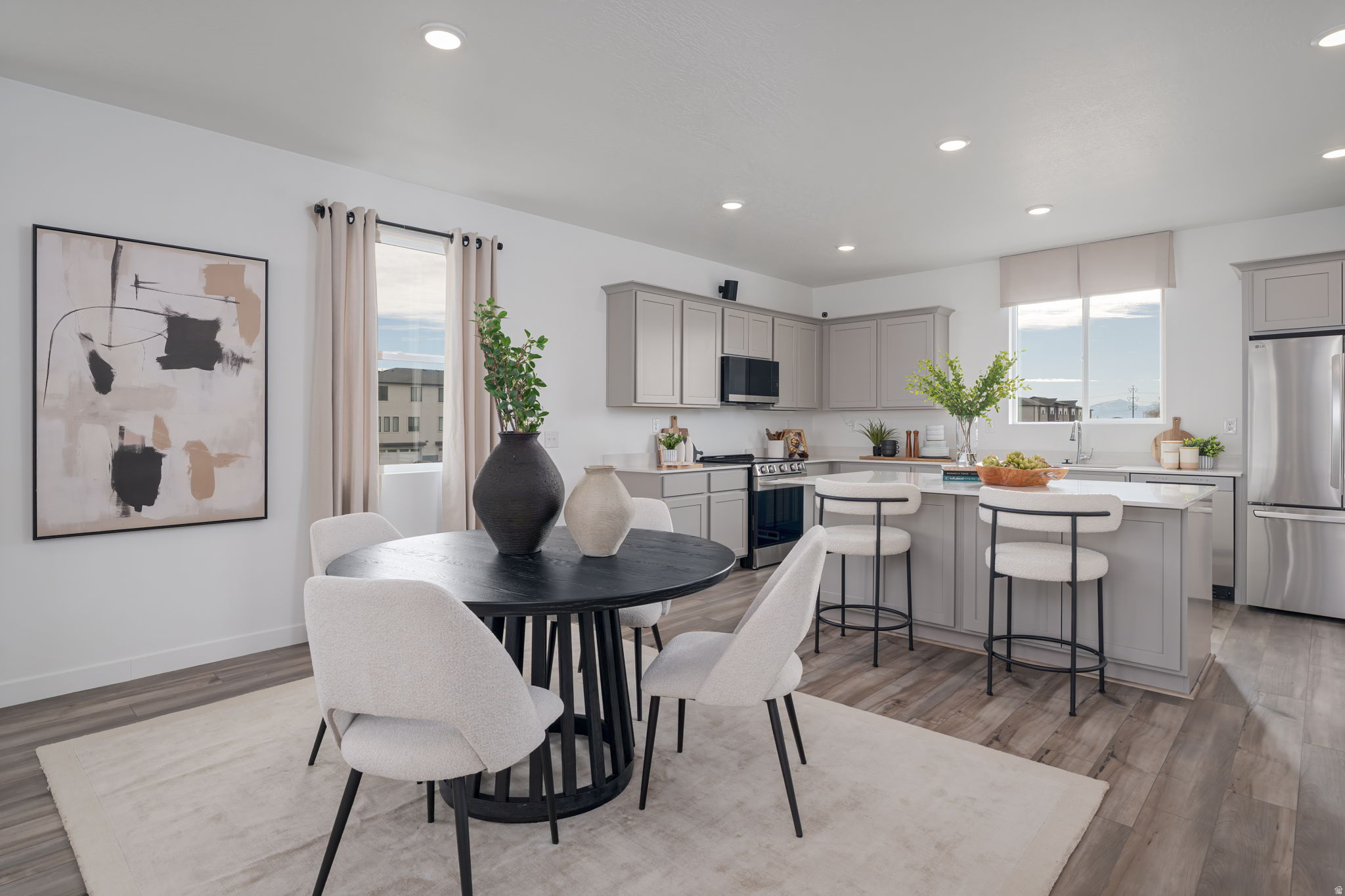 Homesite #282 - The Manhattan floor plan offers three levels of thoughtfully designed living with an open-concept main floor perfect for both everyday life and entertaining. This home features the Warm package with white cabinetry, white quartz countertops, and LVP flooring throughout the main level and wet areas, creating a bright and inviting interior. With 4 bedrooms, 3.5 bathrooms, and 2,163 square feet, there's flexible space for guests, a home office, or room to grow. This interior unit is located along the community park and includes a full-length driveway for added convenience and extra parking space. Projected completion September 2026. *Photos of model home, options & finishes may vary*