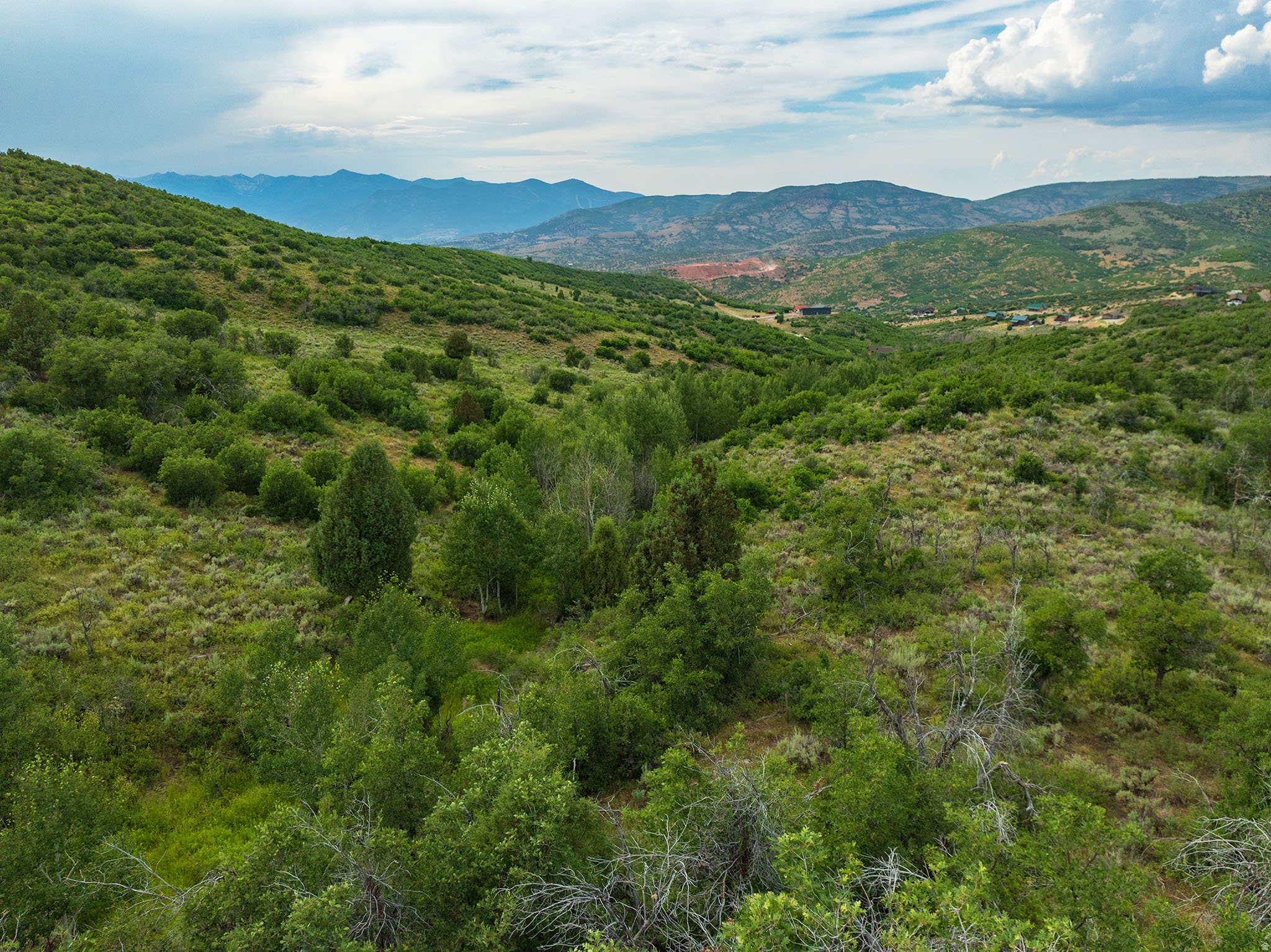 Want acreage, a seasonal stream, and a cabin lot in the mountains only 1 hour from SLC? Year-round access and utilities afford easy year-round mountain living on this extra-large *1.5-acre* Timber Lakes building lot. Timber Lakes is a residential/recreational mountain community just 7 miles east of Heber and 35 min from Park City. Guard-gated, private community with year-round water, utilities, services & access. Residents enjoy private winter access directly to the Uinta National Forest! Large, south-facing downhill lot will easily accommodate a future walk-out/daylight basement. One of the most "private" lots on the west side because this lot is at the end of the cul-de-sac and borders privately owned LDS Church Camp land that won't ever be developed. Only 1 neighbor to the east! Survey complete, percolation tests complete, and "Letter of Feasibility" from Health Dept confirms septic is feasible. South-facing with lovely mountainside and Heber Valley views. Lot dimensions: 150' frontage, 377' side lengths, 167' rear property line. Very easy access on maintained gravel roads for year-round mountain living or weekend getaways. Wildlife, nature, streams, lakes, epic snowmobiling, and ATV adventures await! Within 1 hour of SLC and Provo!