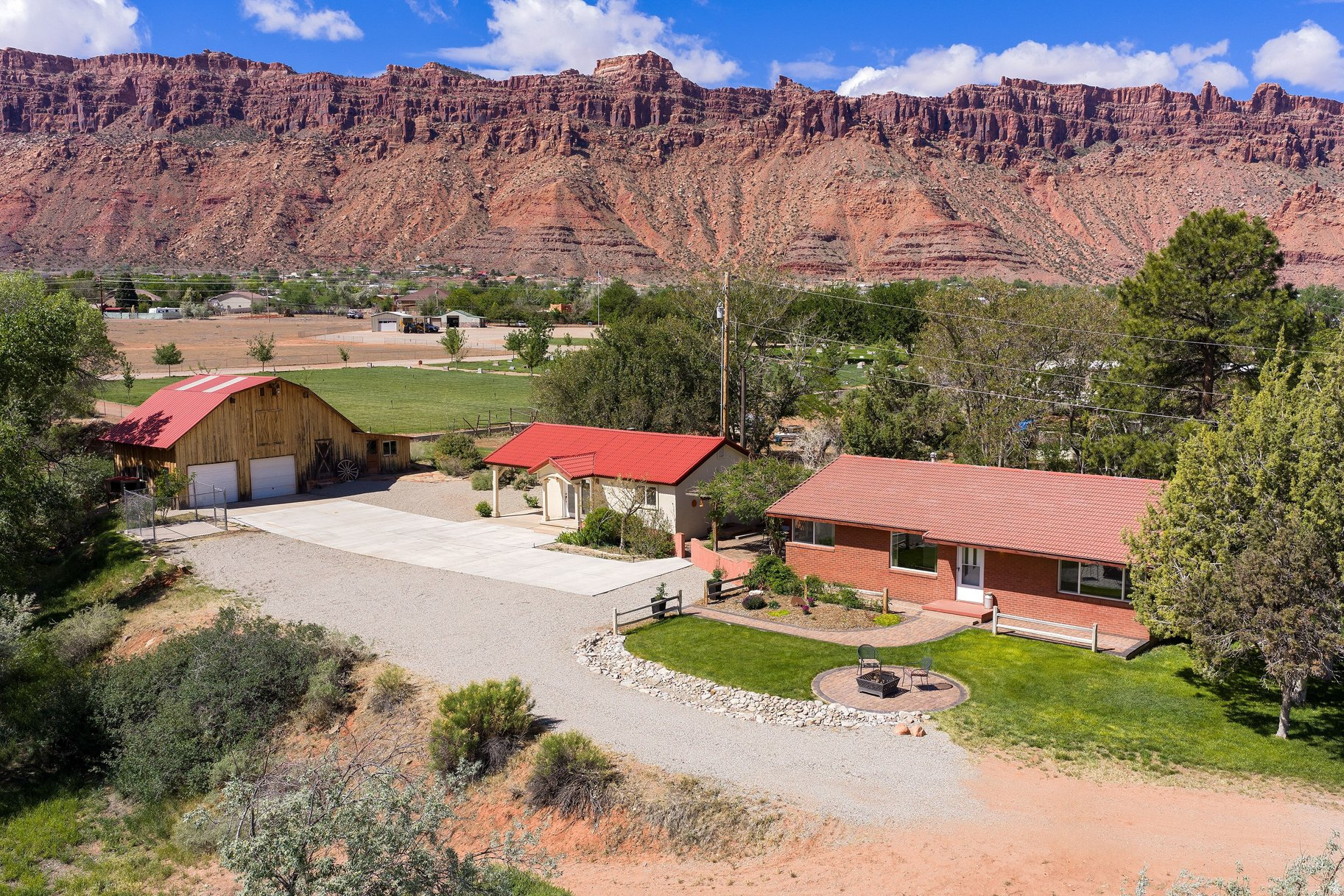 Welcome to your dream horse property at 2810 Nuevo Court. Set on 2.87 acres, and tucked away from busy streets and neighboring homes, this private oasis offers peaceful living just ten minutes from town.  The main house features 2 bedrooms and 1 bathroom, with new appliances and original hardwood floors. Mid-century details, a cozy fireplace, and an open floor plan create a warm, inviting space. A spacious laundry room and classic brick exterior add both function and charm.  A beautifully designed patio connects the main house to the mother in law studio-an ideal setting for slow mornings or relaxed evenings, all framed by stunning red rock and mountain views. Lovingly maintained over the years, this outdoor space is truly a highlight of the property.  The mother in law offers a versatile guest studio or rental opportunity, complete with a small kitchen, bathroom, fireplace, and durable stucco exterior.  The barn provides endless potential-perfect for horses, storage, a workshop, or creative pursuits. Equipped with electricity and a tack room, it's ready to suit your needs.  Set on an oversized lot with subdivision potential, zoned LLR, this property offers flexibility for the future-build your dream home while generating income from the existing residences. A horse corral, spring fed pond, water well for irrigation, and ample open space provide plenty of room for horses to roam and graze, making this a rare and well-rounded equestrian opportunity.