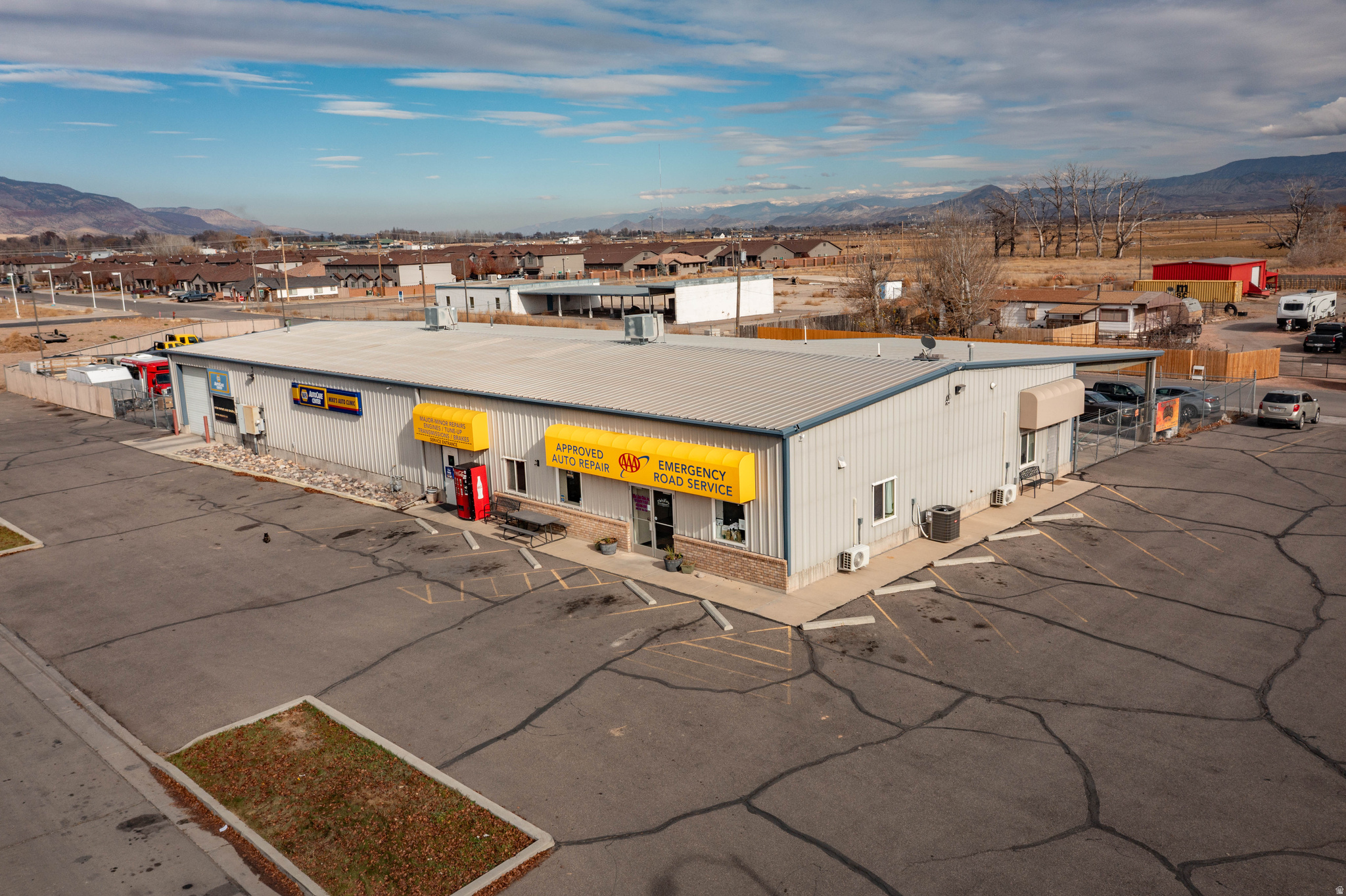 Prime commercial building with auto shop and three income-producing tenants. Located at 1075 S 75 East in Richfield, this 7,450 sq. ft. facility on 0.88 acres sits just one block off South Main near Walmart and I-70. The property includes five service bays, upgraded AC (2025), fully asphalted parking and storage areas, and an oil-water separator-significant cost savings compared to new construction. The site benefits from rare grandfathered industrial zoning, eliminating today's impact fees and drainage requirements typically imposed in the industrial park.  Three small suites currently leased to an auto detailer, salon, and bookstore provide approx. $1,950/month in additional income. When combined with the auto shop's operating income, the projected performance indicates an estimated CAP rate of 10.25 %, depending on buyer structure and whether the business is acquired alongside the property (buyer to verify all financials independently).  Mike's Auto Clinic, a respected 35-year business, along with its trained staff, customer base, and approximately $200K in equipment, may be purchased separately. Financials are available with a signed NDA. Seller is willing to assist with transition, making this a strong turnkey owner-operator or investor opportunity.  Growth potential includes towing, heavy-equipment/AG repair, fleet services, body/paint, or equipment rental (buyer to verify). List price reflects real estate only; business and equipment are optional.