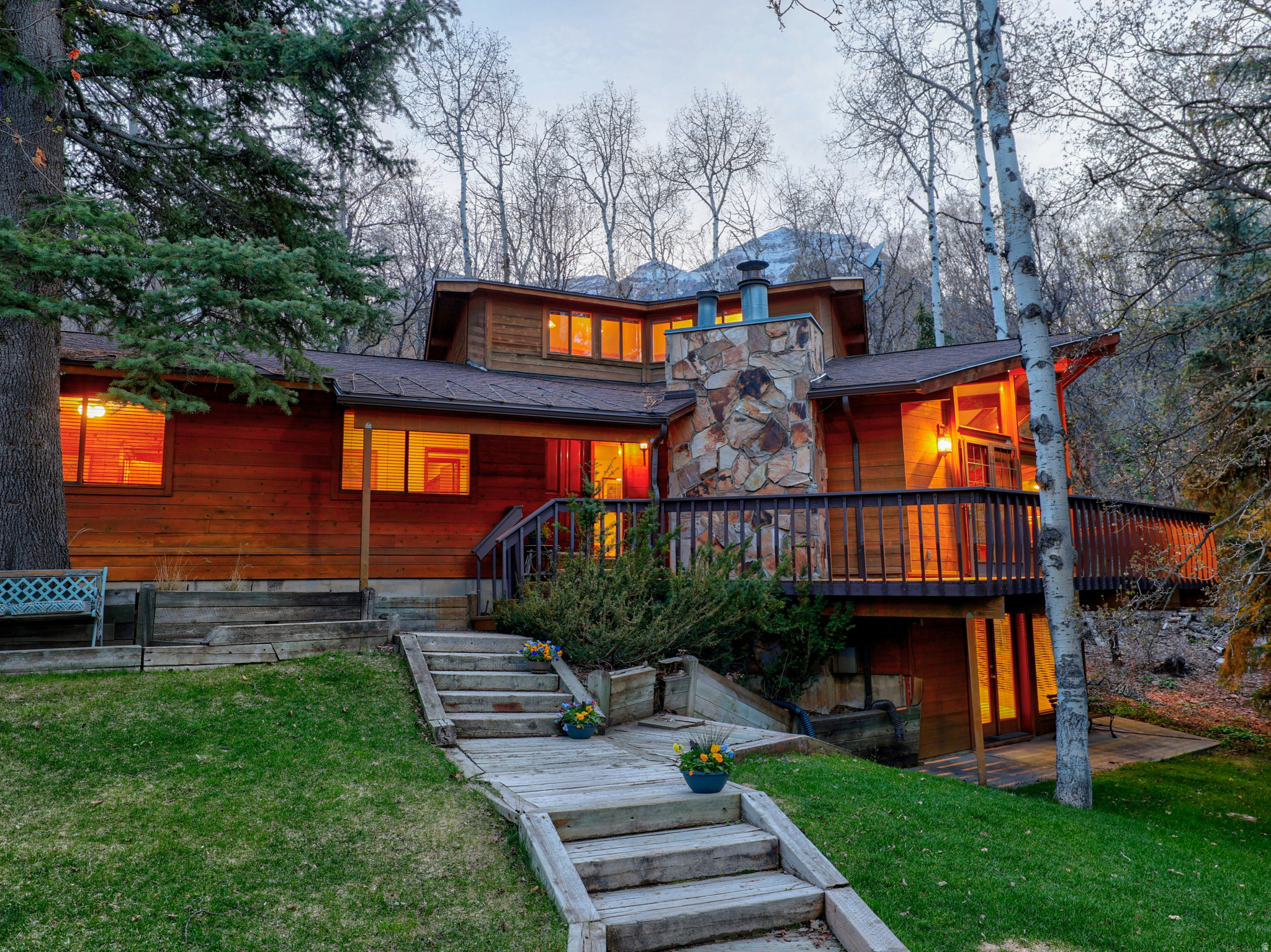 PRICE JUST REDUCED!! LOCATION, LOCATION, LOCATION! This mountain home is a rare find; one of the closest homes to the Sundance ski village. Whether you're dreaming of a 5-minute walk to the ski slopes with no crazy traffic, enjoying cool and peaceful summer evenings in the pines, or you want a smart investment that can pay for itself in rental income, you've found it!  This home brings the rustic character, comfort, and convenience that make Sundance feel like the mountain home you've always wanted. Perfectly located on a sun-filled, neighborhood road with very easy year-round access and lots of usable yard space, this property also boasts a flat driveway with parking for up to 7 vehicles and a large, beautiful yard. You and your family will enjoy the easy stroll down to the resort village to participate in its many activities, and you'll love the private outdoor dining this home has to offer, for large or small groups, with a very spacious deck surrounded by pines, maples and aspens. There's plenty of seating and dining space, plus room for a hot tub. Inside the main living area are soaring vaulted ceilings, floor-to-ceiling windows that pour in the natural light, a crackling, wood-burning fireplace, and an open, airy layout; perfect for entertaining. Five bedrooms and four baths give everyone their own space, while the daylight, walk-out basement with a wall of windows and wood burning fireplace is ready for game and movie nights. All furnishings come with the house except a few special art pieces and personal items. Square footage figures are provided as a courtesy estimate only and were obtained from appraisal.  Buyer is advised to obtain an independent measurement.