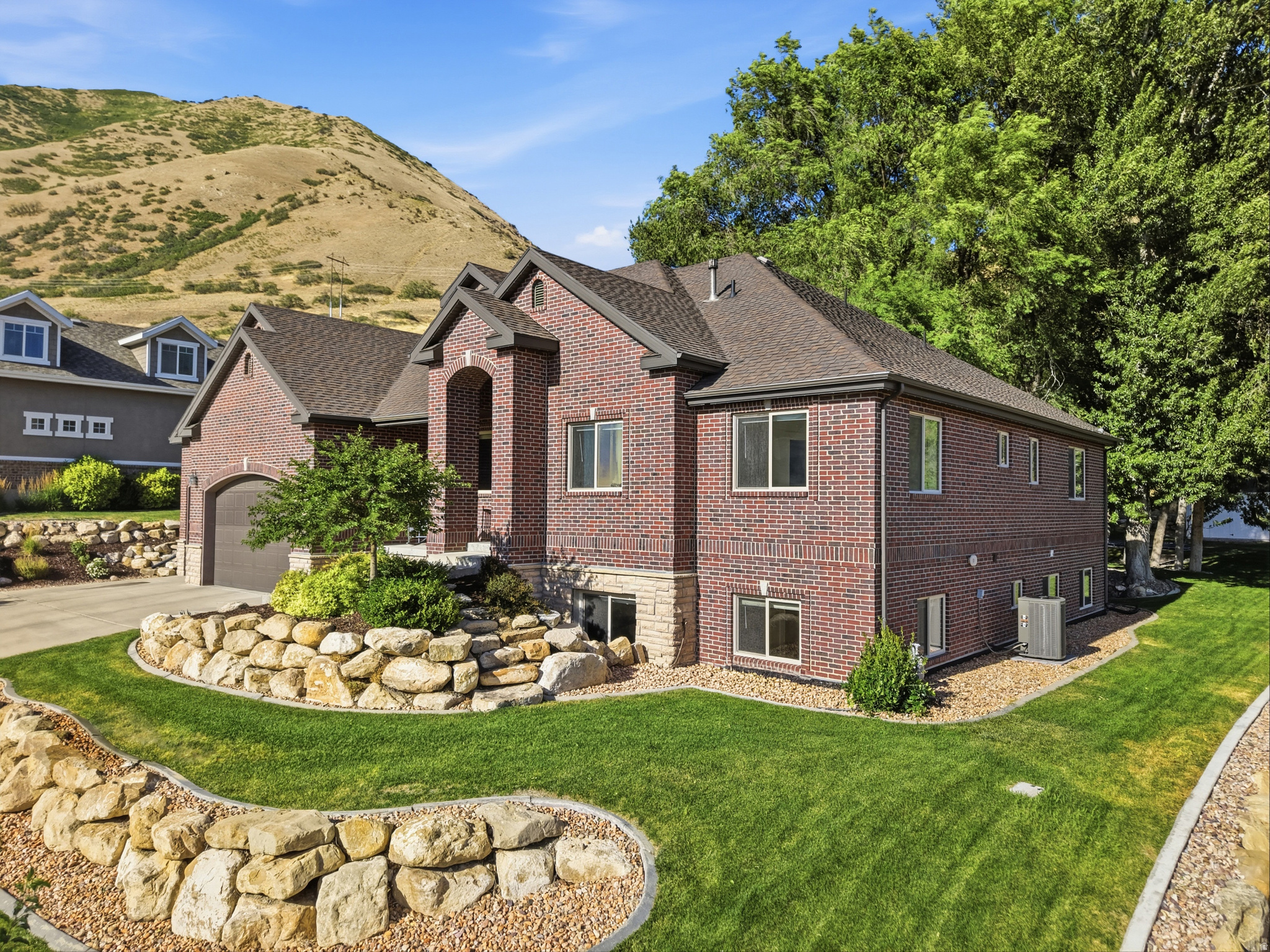 Tucked away in one of Springville's most sought-after Cherrington Heights neighborhoods, this beautifully updated home sits on an exceptional .46-acre lot backing directly to the mountains, with private access to biking and hiking trails right out your back door. Towering mature trees, breathtaking mountain and valley views, and a peaceful backyard create a truly one-of-a-kind setting.  Inside, the open-concept floor plan is filled with natural light and features an oversized refrigerator and freezer, a functional mudroom with built-in lockers, a main-level primary suite, additional private suites upstairs and in the basement, and a theater room. Enjoy entertaining under the expansive covered patio or relaxing in your own backyard retreat.  Additional highlights include a separate basement entrance, oversized garage, new carpet, new blinds, a newer roof, a high-efficiency thermal envelope for lower utility costs, and a furnace and A/C replaced just two years ago.  Homes in Cherrington Heights rarely come on the market. Just minutes from Cherry Ridge Bike Park, Hobble Creek Canyon, top-rated schools, shopping, and dining, this home offers an unmatched combination of privacy, views, direct trail access, and convenience.  Square footage figures are provided as a courtesy estimate only and were obtained from county records. Buyer is advised to obtain an independent measurement.