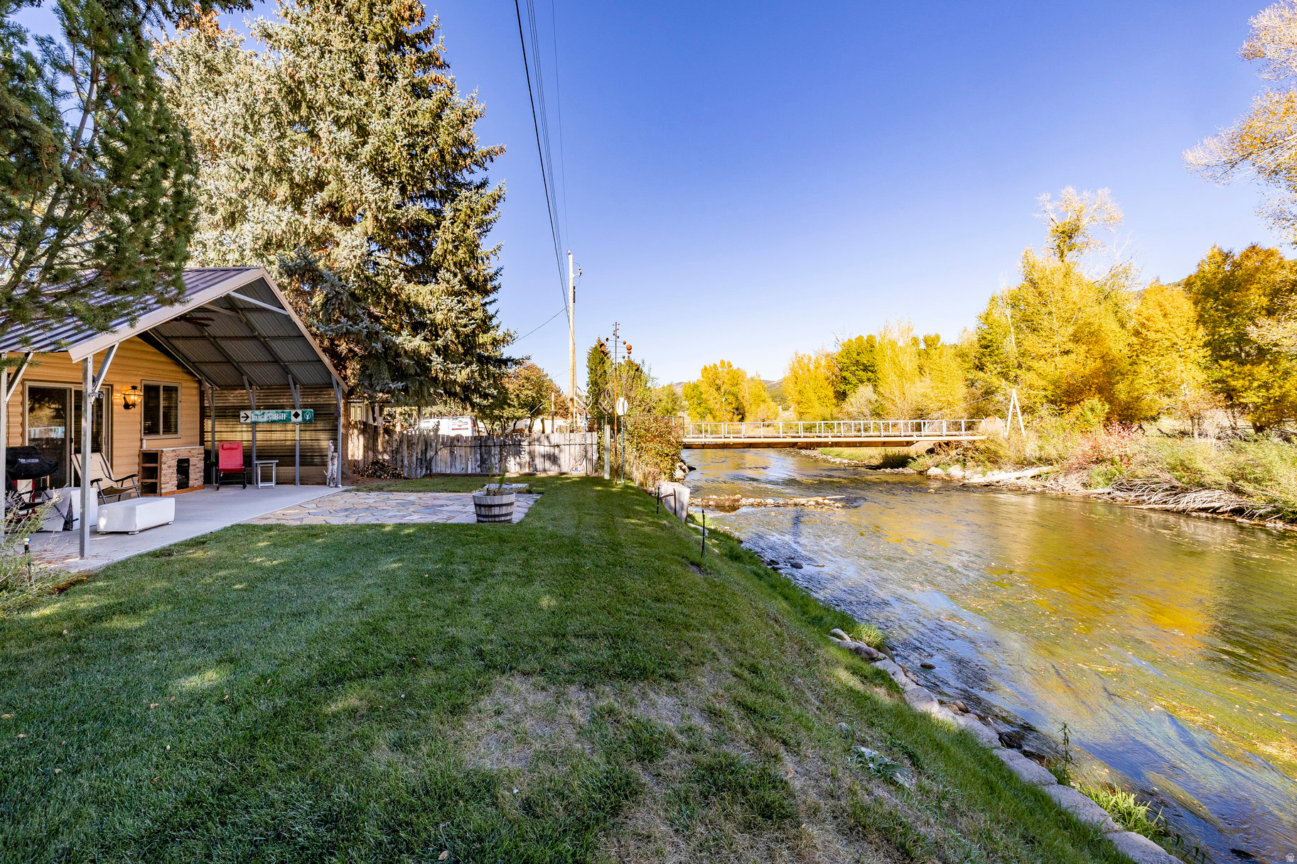 Welcome to an exceptional, one-of-a-kind property located on 60 feet of private Weber River frontage in Wanship, Utah. This unique setting offers year-round access and a serene retreat, all while providing easy access to the stunning Uinta and Wasatch Mountains, several nearby lakes, and the renowned mountain resorts of Park City Mountain, Deer Valley Resort, Powder Mountain, and Snowbasin. The home is equipped for comfortable, modern living with natural gas, electricity, culinary well water, and satellite internet. Key updates include a newer roof and an oversized, heated garage, ensuring durability and convenience. Outside, there is covered RV parking, and a covered patio overlooks the peaceful river, offering the perfect spot to relax and watch the water flow by. Inside, a versatile den provides a flexible space that can be adapted for use as a third bedroom, a dedicated office, or any other flex space you may need. Additionally, the property comes with one share of Weber Water for irrigation, adding to its appeal.