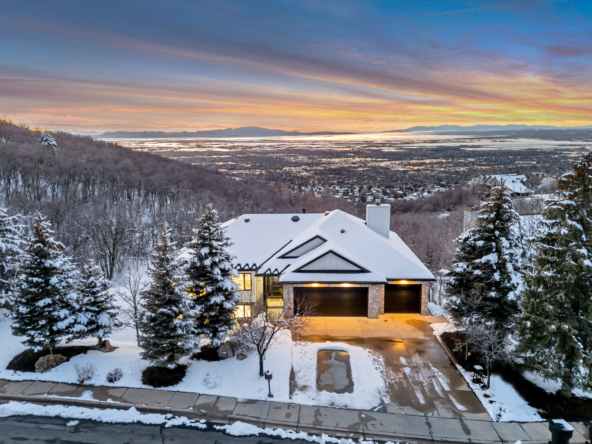 A Masterpiece for the Discerning Perfectionist! This isn't a typical listing-it's an invitation to acquire a once-in-a-lifetime architectural work of art. The owner, a builder and perfectionist, spent four years pursuing absolute quality, and seeks a buyer who values true craftsmanship over "by-the-numbers" appraisals. Perched on Bountiful's prestigious East Bench, the home commands unobstructed valley and Great Salt Lake views from a quiet cul-de-sac-offering privacy, safety, and a serene setting. Nestled against the mountains, with water resting at its feet-this home sits in the valley between two peaks, positioned in the classic feng shui form of "leaning against the hill, facing the water." It's a setting where prosperity settles in and grows"-the kind of place that just feels right.  Despite this peaceful retreat, downtown Salt Lake City is 15 minutes away, the airport under 20, and amenities just 510 minutes. World-class skiing at Park City is a 40-minute drive, with two top-ranked public golf courses within two miles. Architectural Highlights: Commercial-grade construction: cement board siding, brand new roofing, and a 2,000+ sq. ft. view deck with crystal glass and stainless steel railings * Italian stainless steel entry door-a bold, sculptural first impression * Solid oak millwork throughout, plus commercial-grade soffits, fascia, and gutters* Sculptural interior staircase with frosted crystal glass treads on a steel structure * High-performance aluminum windows and doors with integrated blind technology-blinds sealed permanently between glass panes, powered by solar panels on frames for zero-maintenance operation; bifolding doors in living areas dissolve indoor-outdoor boundaries *  Hand-smoothed walls and ceilings-a hallmark of true high-end construction * Gourmet kitchen with natural crystal stone island (motion-activated illumination), custom marble backsplash, and FOTILE touchless range hood * Bathrooms clad in large-format marble slabs with honed marble floors, custom low-iron glass shower doors featuring precision soft-closing systems for silent, smooth operation, and anti-fog mirrors *  New HVAC, plumbing, electrical, plus designer garage door and epoxy garage floor with marble baseboards * This is not merely a home-it is a legacy of beauty and uncompromising execution.   Square footage figures are provided as a courtesy estimate only and were obtained from a prior listing. Buyer is advised to obtain an independent measurement.
