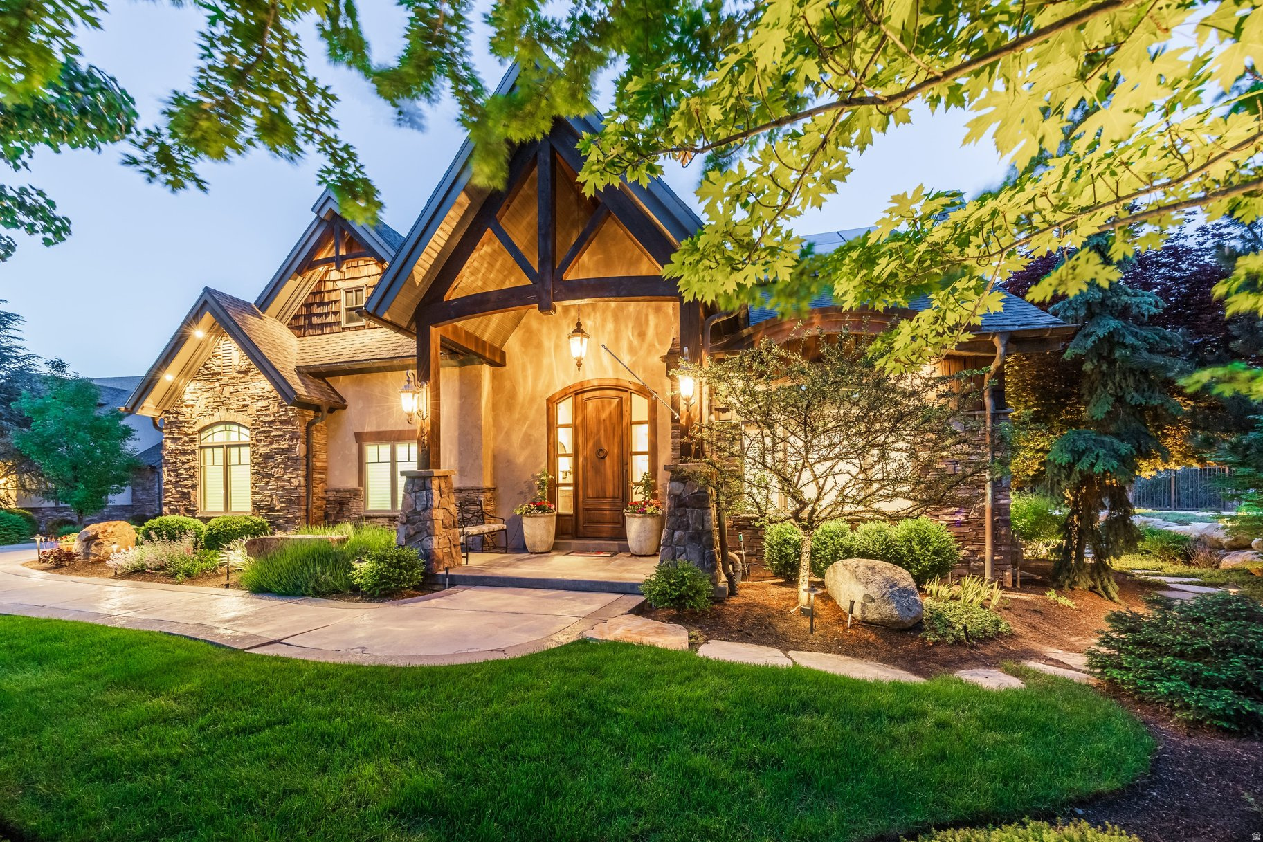 Tucked discreetly at the base of Little Cottonwood Canyon within an exclusive gated enclave of just six residences, this extraordinary estate offers a rare blend of privacy, tranquility, and refined mountain luxury. Surrounded by towering mature trees and impeccably curated landscaping, the grounds feel more like a private resort-complete with a serene artificial creek, cascading waterfall, and thoughtfully designed outdoor living spaces that create an atmosphere of complete retreat. Designed for both elevated entertaining and effortless everyday living, the residence showcases sophisticated interiors with seamless smart-home integration, including automated window coverings and a whole-home sound system. The stunning primary suite serves as a true sanctuary, featuring a spa-inspired bath and an impeccably designed custom closet. The heart of the home is the chef's kitchen, beautifully appointed with premium finishes and complemented by an elegant butler's pantry for seamless hosting and organization.  Offering four spacious bedrooms and four luxurious bathrooms, the home also features a fully equipped walk-out lower level with private terrace access and an additional kitchen-perfect for guests, multigenerational living, or elevated entertaining. A three-car garage, owned solar system, and a fully automated greenhouse with independent heating and cooling controls add a rare layer of sustainability, functionality, and lifestyle versatility seldom found in homes of this caliber.  This is canyon living reimagined-where luxury, privacy, and nature exist in perfect harmony just 10 minutes from freeway access, and moments from world-class skiing, hiking, dining, and the best of the Salt Lake Valley.