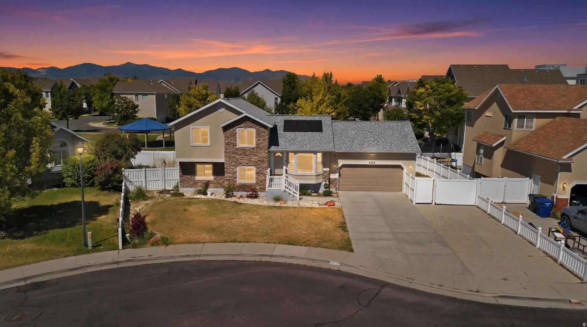 Paid-off solar panels, a heated oversized garage with EV charging, a covered composite deck, and extensive upgrades throughout make this move-in-ready 5-bedroom home a standout. Features include a custom fireplace, granite countertops, stainless steel appliances, fresh interior paint. AC with air scrubber and humidifier, water heater and water softener have all been replaced within the last few years. Enjoy year-round outdoor living on the private covered deck complete with roller shades, ceiling fan, and fire pit area. The fully fenced and landscaped yard offers mature landscaping, automatic sprinklers, and a powered storage shed. Conveniently located near parks, schools, shopping, and commuter access. Priced to sell, this turnkey property offers the perfect blend of comfort, efficiency, and value. Schedule your private showing today! All information herein is deemed reliable but not guaranteed; buyer is advised to verify all information.