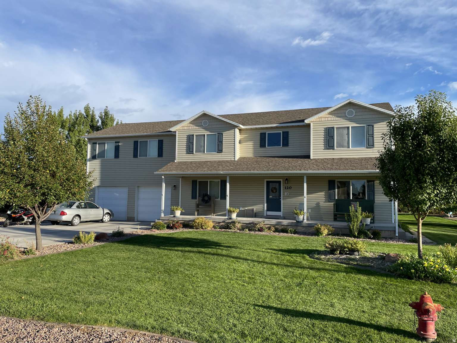 Large home on 1 acre with 1 share of irrigation water. 2810 s.f. plus 1200 s.f. of cemented, well-lit, stair-accessible crawl space. 8' by 40' front porch. 5 large bedrooms, 2 full baths 1 half bath, 2 living rooms, library, laundry room, and large garage. Has 2 furnaces (1 for each level), 2 ac units, on-demand tankless water heater installed in 2025. Home has had radon mitigation. Two gas fireplaces, 2 sun lights, intercom system, plumbed for vac system. Dryer & range are plumbed for both gas and electricity. Kitchen updated in 2020 with custom cabinets and granite counter tops, front entry way updated in 2023 w/ beautiful oak stairs, new carpet throughout. Two security cameras. Large, shady yard with a 10'x12' shed, a green house, and built in fire pit. Producing choke cherries, nanking cherries, current bushes, and apple tree. Large garden area. Room to add a large detached garage.  Excellent neighborhood on a quiet street. Zoned for animals. Rural feel, but in town location.