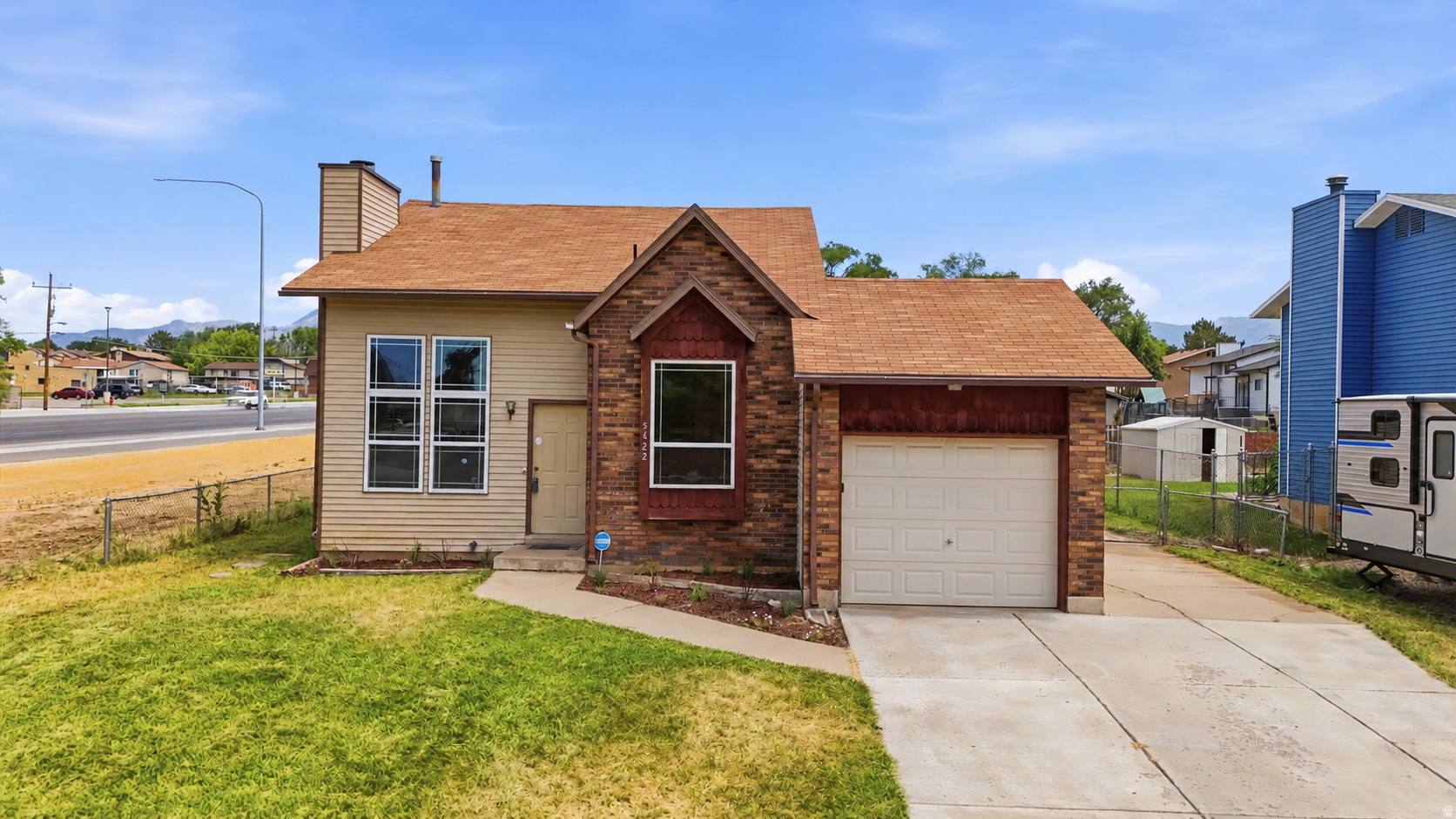 NEW carpet, NEW fence, NEW ceiling fans. Other MAJOR UPDATES already done, including roof (2017), LVP flooring (2018), water heater and A/C (2019), and garbage disposal (2020).  Spacious and functional tri-level in Roy, less than 5 minutes from Hill AFB! This home offers 3 bedrooms, 1.5 baths, 2 living areas, soaring 15' vaulted ceilings that create an open, airy feel, and an attached 1-car garage with RV parking. Outside, enjoy a large backyard with a brand new fence, covered patio, garden beds, and a dog run. Conveniently located near Hill Air Force Base, shopping, Roy Elementary, Eagle Lake Golf Course, Roy Aquatic Center, and nearby walking trails. Square footage figures are provided as a courtesy estimate only and were obtained from county records and appraisal. Buyer is advised to obtain an independent measurement.