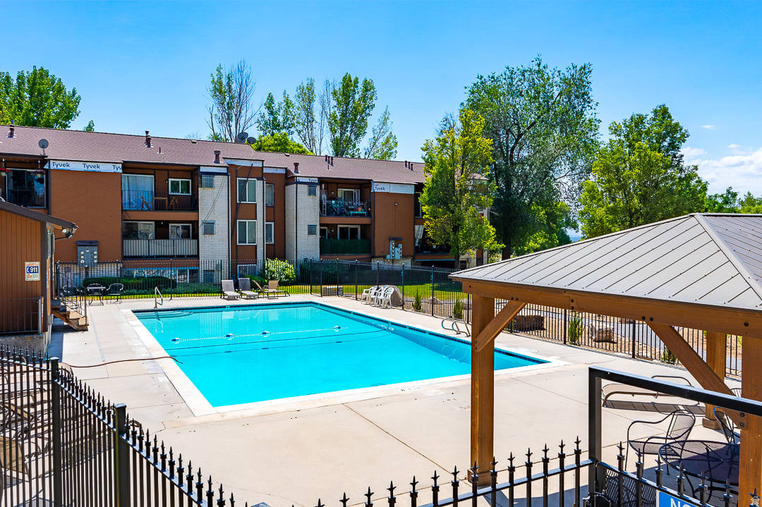 Perfectly positioned in the sought-after Sugarhouse area, this condo offers the ideal blend of comfort, convenience, and low-maintenance living.  Enjoy a very walkable, pet friendly, and charming neighborhood with easy access to shopping, dining, parks, and major commuter routes just minutes from your door yet the complex is tucked into a quiet area with mature trees, a new clubhouse, and a pool.  This condo offers private laundry, a spacious bedroom, large walk-in closet, gas fireplace, dining area, and a private deck which can be accessed from both the front room & bedroom and looks out to the beautifully maintained grounds.  Unit includes multiple private storage areas and a covered parking space plus there's ample guest parking.  Google Fiber available.  New HVAC / AC and furnace; new water heater; new fridge, dishwasher & disposal; new exterior siding; smart thermostat. Ring camera remains. This truly is a little gem!
