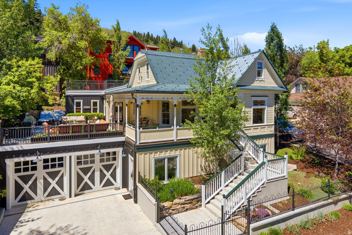 A truly rare offering in Old Town Park City, 733 Woodside Avenue, known as the Larremore Mansion, represents a once-in-a-generation opportunity to own a legacy ski property. Set directly on the Town Run with true ski-in/ski-out access to Town Lift, this 6-bedroom, 7-bath residence offers a combination of location, privacy, and scale that is virtually unheard of in Old Town. Tucked at the end of a quiet dead-end stretch of Woodside Avenue-yet just one block from Main Street-this home delivers the best of both worlds: immediate access to world-class skiing and trails, along with effortless walkability to dining, galleries, shopping, nightlife, and the iconic Egyptian Theatre. Originally rich in historic character and taken down to the studs in a 2017 remodel, the home seamlessly blends timeless charm with modern luxury. The open-concept living is designed for both comfort and entertaining, featuring hardwood floors, abundant natural light, radiant heat, central A/C, Sonos sound system, automated blinds, custom drapery, and a beautiful gas fireplace that anchors the space. The impressive chef's kitchen is appointed with custom cabinetry, Sub-Zero refrigeration, Wolf appliances, an under-counter beverage refrigerator, and a temperature-controlled wine closet on the lower level. Each of the six en-suite bedrooms offers privacy and comfort, complemented by five fireplaces, generous mudrooms, a dedicated study, dual laundry areas, ample storage, and a heated garage, creating a home that lives as well as it entertains. Outdoor living is just as exceptional, with heated upper and lower patios designed for year-round enjoyment with views. Amenities include a gas fire pit, built-in grill, hot tub, outdoor TV, porch swing, and a fenced, low-maintenance yard, all with seamless direct access to skiing and hiking right outside your patio gate. 733 Woodside Ave. captures the essence of Park City living. Private, historic, walkable, and irreplaceable- a legacy property!