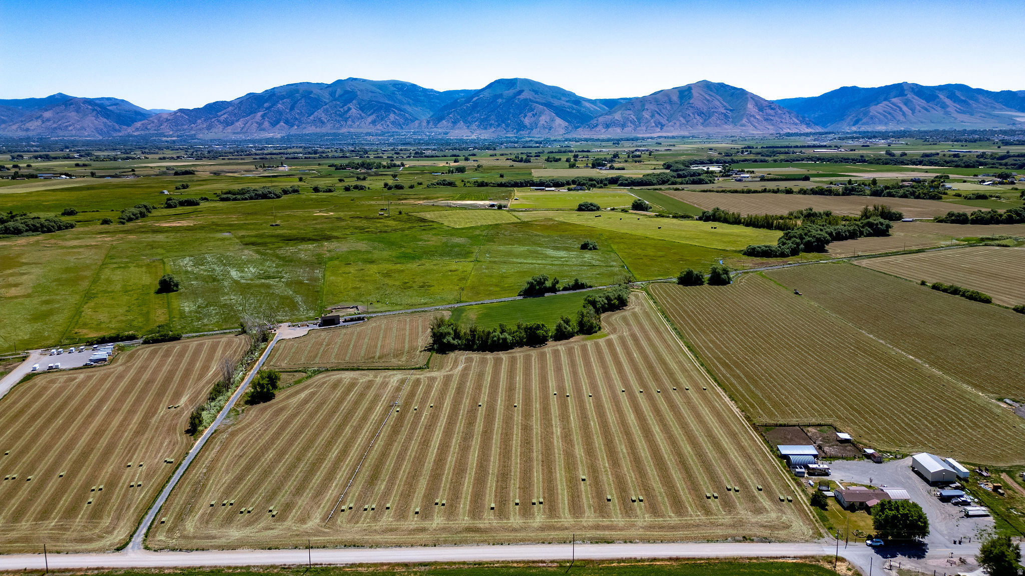 Beautiful 33-acre property in Wellsville with views of Cache Valley and the Wellsville Mountains. Current A10 zoning may allow potential for up to 3 single-family homes on the property (buyer to verify with Cache County), making it a unique opportunity for those looking to build or explore future development potential. The property includes 25 Wellsville-Mendon Irrigation District shares, mature trees, and is currently used for hay and grass hay production. Located on 4800 West with easy access to Highway 23. Buyer to verify all info. and intended uses.  LAND BEING FARMED, PLEASE DON'T DRIVE ON FIELD.