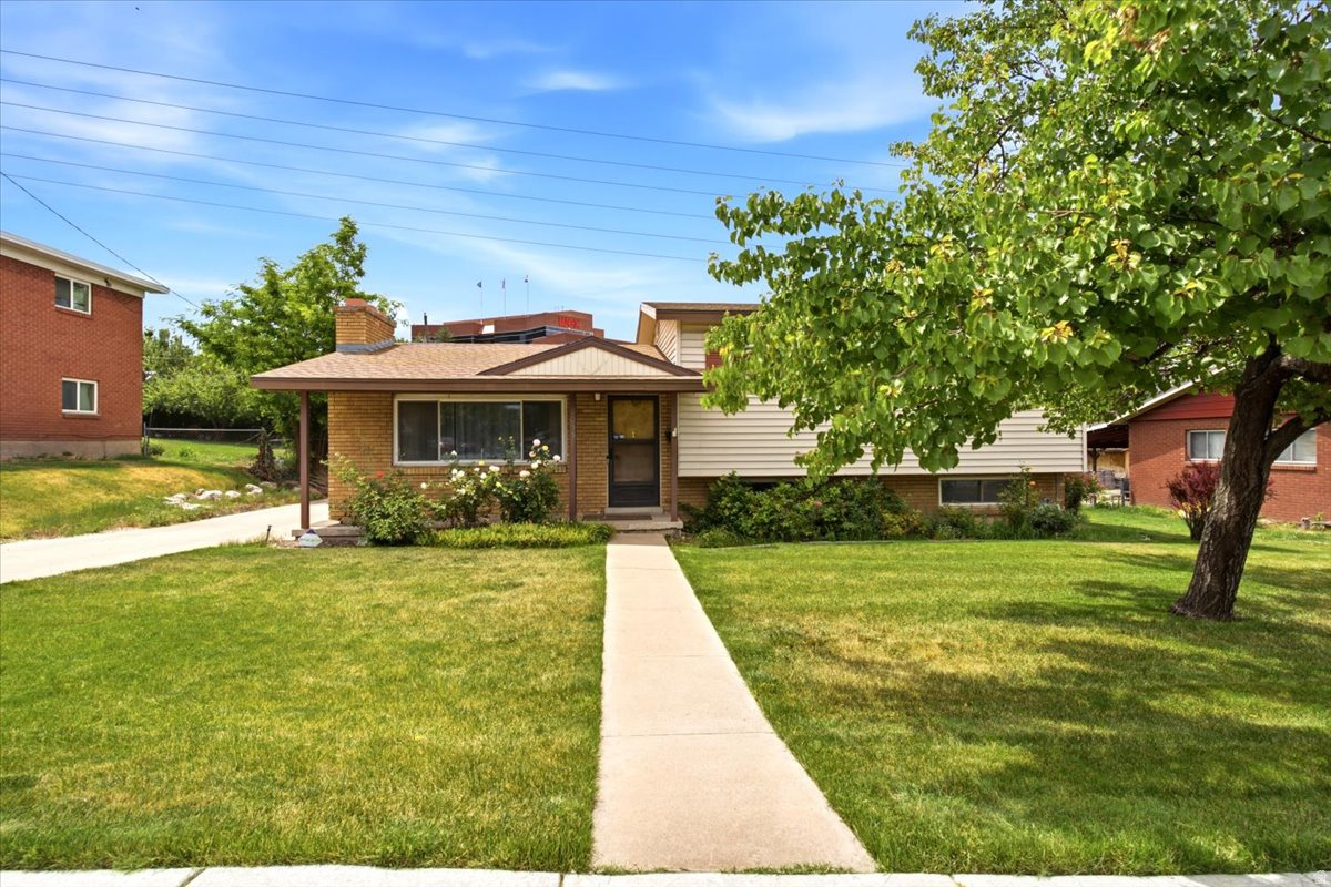Tucked away on a quiet street with no backyard neighbors! Just minutes from shopping and everyday amenities. The fully landscaped yard features a storage shed, carport with additional storage, and plenty of outdoor space to enjoy. Inside, you'll find a comfortable family room highlighted by a cozy wood-burning fireplace. The kitchen comes equipped with a stainless steel refrigerator, electric range, and dining area. A spacious addition provides incredible flexibility and can serve as a second family room, recreation area, or gathering space, complete with a coal-burning fireplace and window evaporative cooler. The home offers good-sized bedrooms, including a primary suite with its own half bath. The basement features a utility/laundry room, while the unfinished lower level presents endless possibilities-finish it as an additional family room, workshop, hobby space, or take advantage of the abundant storage potential. Additional updates and features include newer sewer lines in the home, a new water heater installed in 2025, air humidifier, sump pump, and water softener. With versatile living spaces and a desirable location, this property is ready to welcome its next owner.