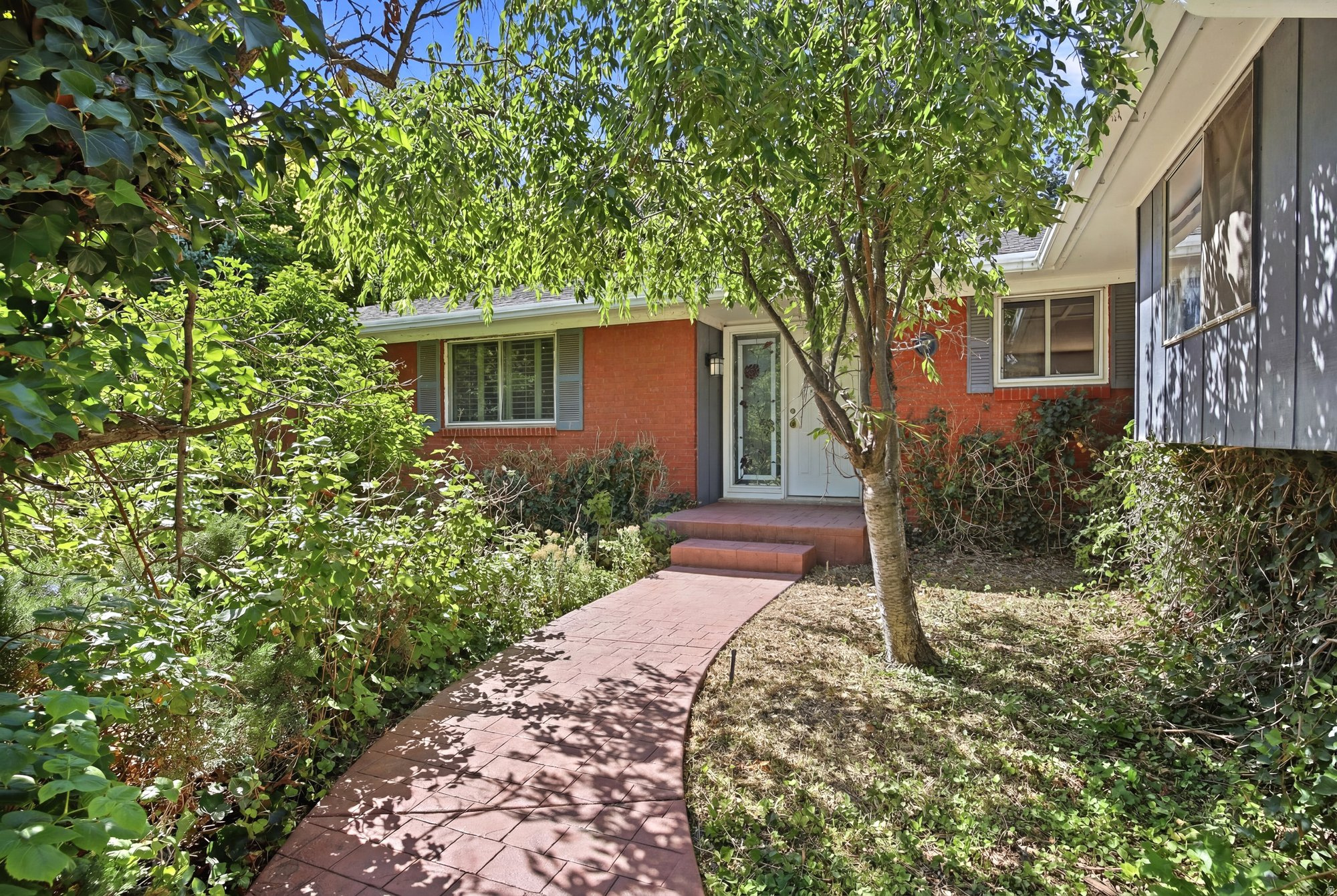 This property, perched ideally in the highly sought-after Uintah Highlands neighborhood, is situated on a special lot that evokes the distinct feeling of living in a forest (while also having convenient highway and shopping access). Appropriately named "Woodland,"  the street is peaceful and welcoming, and the home's yard features just enough trees, plants, raspberry bushes, and a pergola (plus, the occasional wild turkey) to feel like an outdoor oasis. The floor plan here is open in concept and thoughtful in design: living, kitchen, and dining areas connect to one another seamlessly, each surrounded by sliding glass doors that usher in a wash of natural light and allow for easy access to the aforementioned yard. With plenty of updates throughout-new paint and carpet, and on-demand water heater among them-you can rest assured that this is a turnkey purchase (so you can take your time with any future personalization efforts or changes). All told, there's room for everyone here with five bedrooms, four bathrooms, and an office that has a separate outdoor entrance, lending potential for a home business, flex space, or anything else you can think of. A two-car garage and storage shed ensure space for all the extras, but there's also cold storage for preserving all your perishables. There's a lot of charm here, but the real luxury is the kind of space that lets you spread out, settle in, and stay a while.  Square footage figures are provided as a courtesy estimate only and were obtained from county records.  Buyer is advised to obtain an independent measurement.