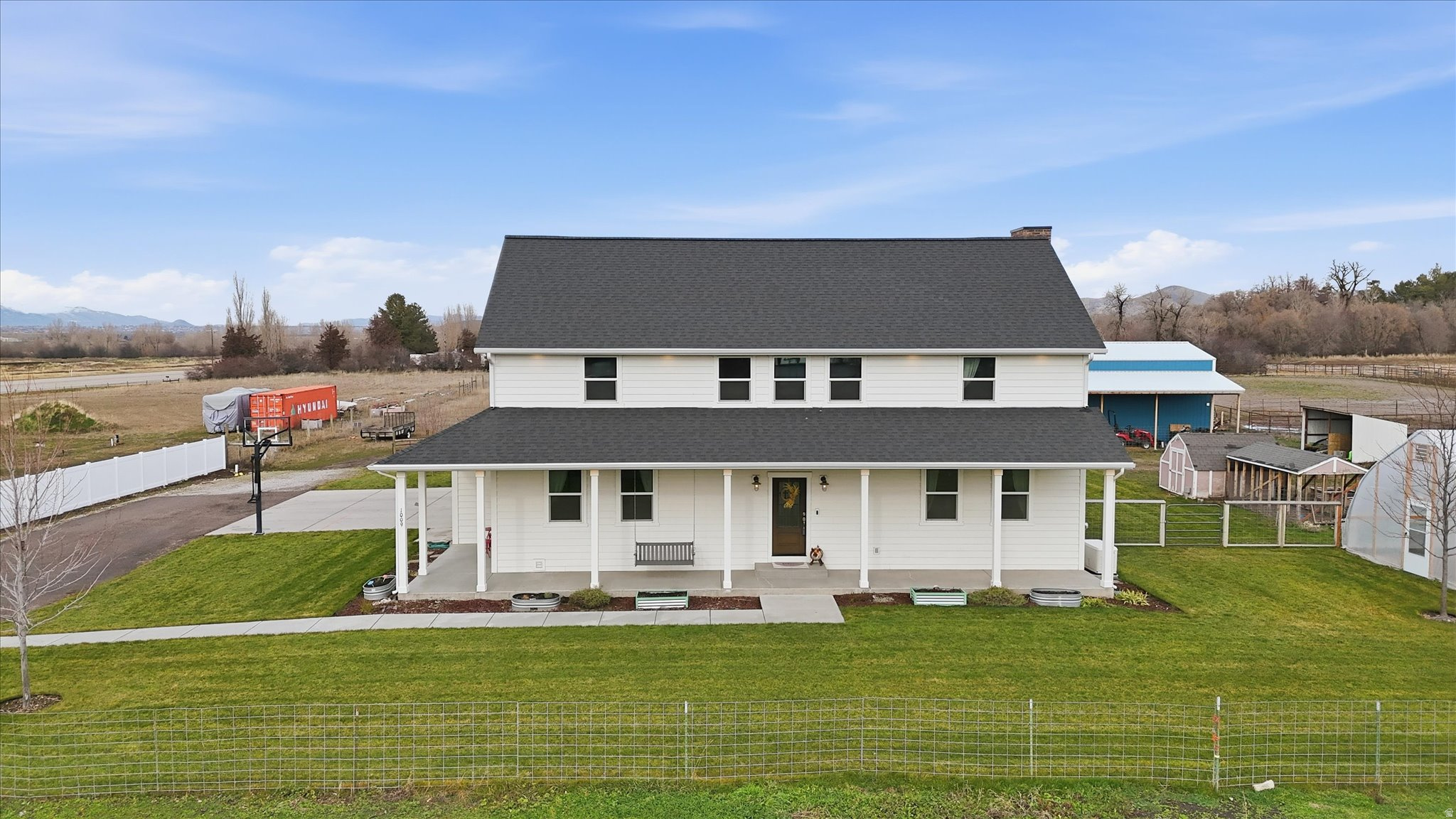 This thoughtfully planned out farmhouse  has THE perfect floorplan & everything you ever wanted in a home. Main floor: Primary bedroom, office, large open great room, plenty of living space both indoor and out, 3 car garage, 24x35 shop, 20x28 greenhouse, a generator, in ground propane tank, large covered patio. Upstairs:  4 large bedrooms and 2 full baths, plus a fun loft, bonus room and home theatre. All this on 3.18 irrigated acreage PLUS a completely independent main level living ADU with no shared walls. Perfect for multigenerational living or additional income. Take a look and see what an amazing value this home is.