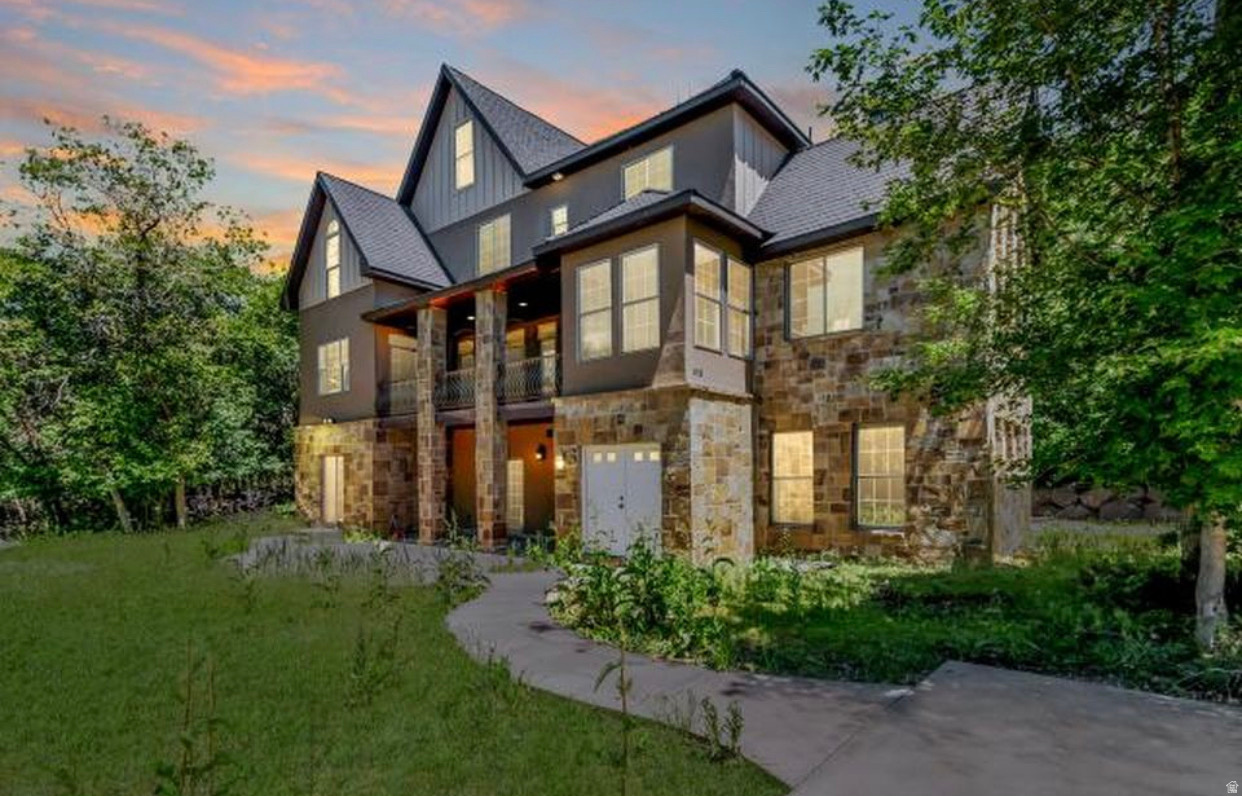 Nestled among the trees with deer and wildlife right outside your door, this extraordinary 3-story retreat offers the perfect blend of privacy, space, and versatility.  Situated on a rare .82-acre corner lot, this expansive home boasts over 5,600 sq. ft. with 7 bedrooms and 5.5 baths, including a fully functioning mother-in-law apartment with its own private entrance - ideal for multi-generational living, guests, or rental income potential.  Inside, you'll discover spacious gathering areas, two cozy fireplaces, and room for everyone to spread out and enjoy. The home is equipped with 3 furnaces for year-round comfort, a newer upper-level A/C, and a durable Ecostar composite 50-year roof.  The built-in 2-car garage is complemented by ample space to add additional garage or shop space if desired.  If you've been searching for a private wooded setting with incredible square footage and endless possibilities, this is the opportunity you've been waiting for.  Priced aggressively for a quick sale at $925,000 - don't miss it!