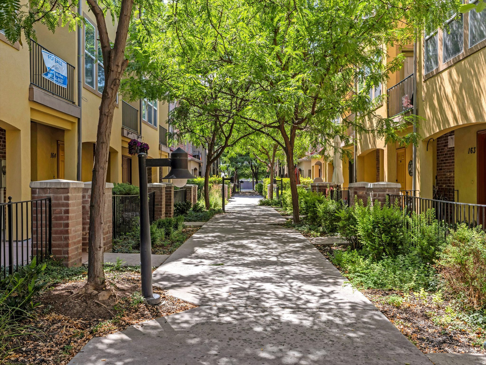 Where Salt Lake's Outdoor Lifestyle Meets Urban Living Experience one of the largest and most desirable floor plans in the community with this spacious end-unit townhome. With only one shared wall, significantly more windows than interior units, this home offers the space, privacy, and natural light that set it apart.  Step outside your front door and into a lifestyle that's hard to match. Walk to The Front Climbing Club, grab a drink with friends at 2nd Summit Cider, unwind at Harmony Park, or hop on the nearby Meadowbrook TRAX Station for effortless access to downtown, the University of Utah, and the entire Salt Lake Valley.   Inside, the open-concept main level is designed for both entertaining and everyday living. The spacious kitchen features granite countertops, abundant cabinetry, and a large center island that flows seamlessly into the inviting living room, where a cozy fireplace creates the perfect place to gather. Nine-foot ceilings and oversized windows flood the home with natural light, enhancing the bright, open feel throughout.  Upstairs, retreat to the oversized primary suite complete with vaulted ceilings, a generous walk-in closet, and plenty of room to create your own private sanctuary. Two additional bedrooms provide flexibility for guests, a home office, or growing families.  Enjoy your own fenced front courtyard along with exceptional community amenities including a clubhouse, fitness center, BBQ areas, playgrounds, open green space, and plentiful guest parking. The HOA also includes fiber internet, water, sewer, trash, snow removal, and grounds maintenance, making homeownership as easy as it is enjoyable.  Combining one of the community's largest layouts, an unbeatable walkable location, and the convenience of a private two-car garage, this home offers an exceptional opportunity to enjoy the best of Salt Lake City's vibrant west side.