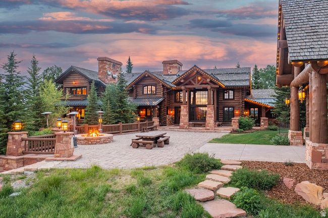 Welcome to one of the most iconic estates in Wolf Creek Ranch, where true Western authenticity meets refined luxury. Located on 160 private acres-with an adjacent 160-acre parcel also available for acquisition. Situated in the heart of this exclusive gated community, this extraordinary property offers endless privacy, panoramic mountain and aspen views, and world-class amenities just 25 minutes from world class skiing at Park City and Deer Valley. Salt Lake International airport is 1 hour and Heber Municipal airport just 10 minutes to the gate. The main residence spans nearly 16,000 square feet, built in timeless log-style architecture with soaring beams, artisan stonework, and curated luxury finishes throughout. A grand chef's kitchen anchors the home with top-tier appliances and custom cabinetry, opening to a stunning dining room and multiple entertaining spaces. Enjoy movie nights in the upgraded home theater, or step outside to grand patio and log pavilion with a dramatic stone fireplace, oversized gas firepit, and in-ground jacuzzi-all positioned to take in the estate's sweeping alpine vistas. Follow a private gravel drive to one of the property's most unique and enchanting features: a secluded 1.6 acre stocked pond, complete with boathouse, dock, horseshoe pit and sandy beach-a hidden oasis perfect for casting a line, kayaking, or stargazing. A 1,883 sq ft guest house offers independent accommodations, while a 4,466 sq ft equestrian barn supports full horse facilities or versatile recreational use. The estate also features radiant in-floor heating, even in select exterior patio areas, a new Lutron smart home system, separate well and water shares, and a backup generator capable of powering property. This is more than a home-it's a private sanctuary & legacy asset in one of the most breathtaking mountain ranch communities in the West. Schedule a private tour and experience the unmatched serenity, scale, and splendor of Wolf Creek Ranch. Sold furnished.