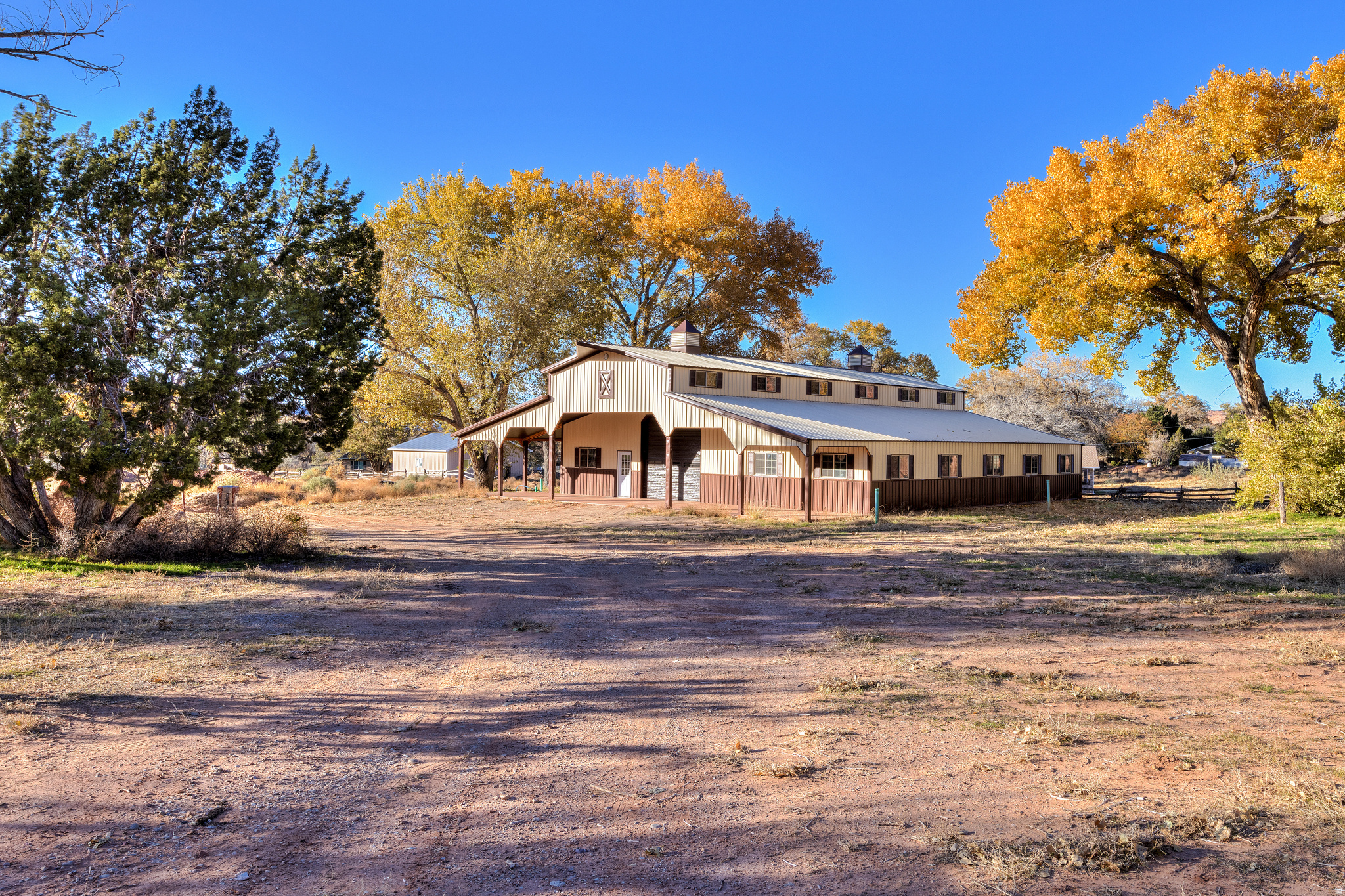 PRIZED AGRICULTURAL ACREAGE located on coveted East Bench Road. Over 7 acres of rural land with a near 4,000 square foot barn in place with animal rights.  Zoned Rural Residential, this parcel has the capability to stay as your spacious estate or subdivide the land with potential of smaller tracts with an approved preliminary plat of 5 parcels. East Bench Road enjoys minimal traffic, a serene setting, and stunning vistas.  The property offers mature Fremont cottonwood trees creating desirable shade and abuts State Land, as well as conservancy land creating  a shelter of privacy. The barn is 56' x 72' and 22' tall, featuring a covered patio, carport space, three horse stalls, and a 14-foot-high roll up door. There is an irrigation well in place with over 40 acre feet of deeded water rights, stubbed power, sanitation, and culinary water- all ready for you and your vision for this dream property's bright future!