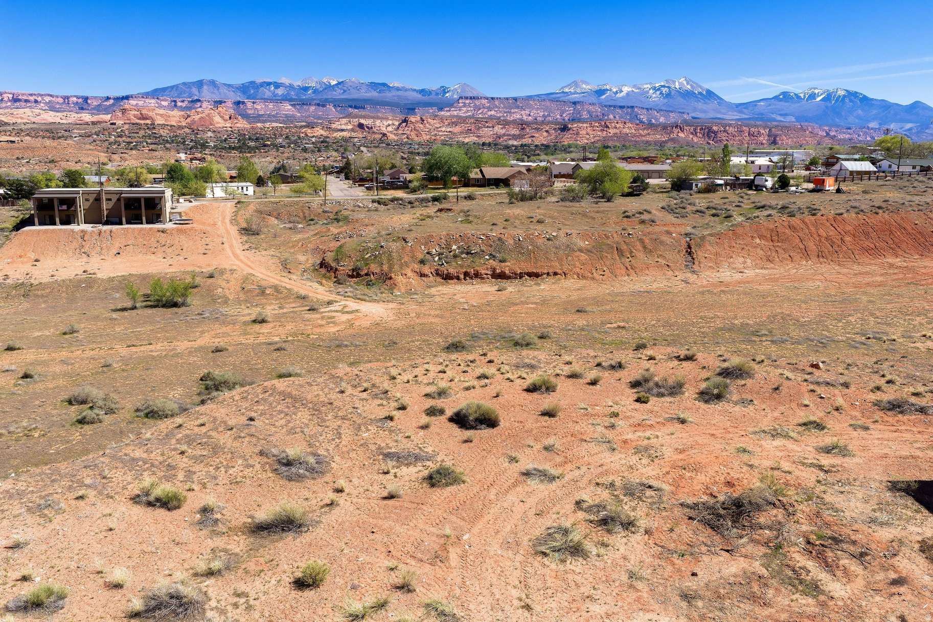 Commercial Opportunities Close to Downtown. Position your business for success with this commercial lot ideally located just four miles from downtown. Zoned Highway Commercial, this property offers flexibility for a wide range of development possibilities-retail, office space, sales and service, housing and more. Set against a stunning backdrop of the La Sal mountains and iconic red rock landscapes, this lot combines high visibility with stunning views. Billboard on property provides some income. Buyer will need to obtain access easements from both DOT and SITLA.