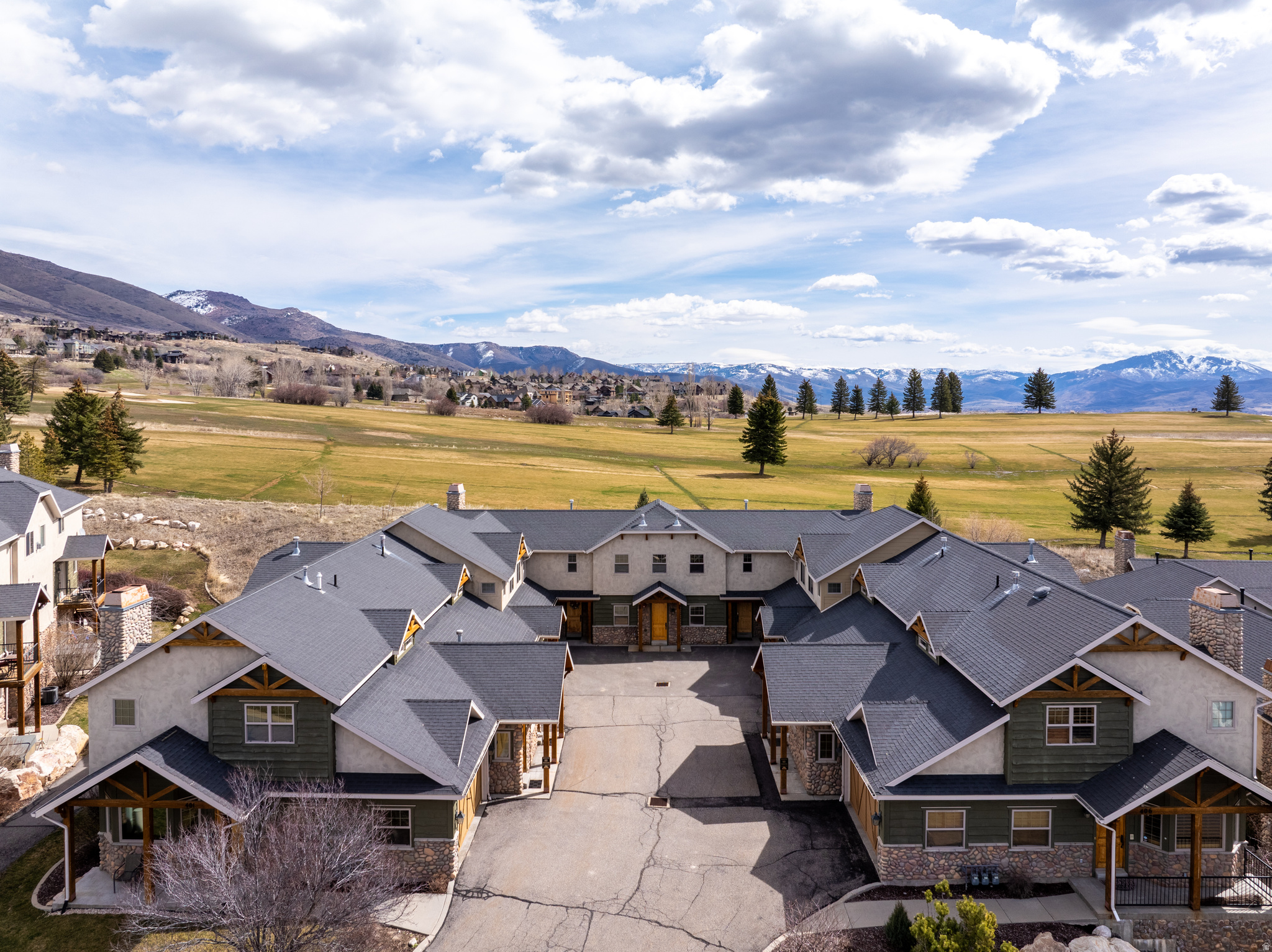 Private outdoor hot tubs are rare at The Cascades - this corner-unit townhouse has one, plus a home theater and golf course views. This 4-bedroom townhouse is one of the few units in the community with one - not the shared spa down at the clubhouse, but yours, on your covered deck, overlooking the Wolf Creek Golf Course fairways and the valley beyond. The corner position adds privacy that interior units can't offer, with natural light on two sides and no shared wall on the end.  Inside, 2,719 square feet across three levels gives groups genuine room to spread out. The main level great room opens to the deck through French doors, anchored by a gas fireplace and a kitchen with granite counters and double ovens - functional for a family, and photographs well. The primary suite has its own private entrance and a jetted tub. The lower level delivers a dedicated home theater with projector - the kind of amenity that fills a booking calendar on ski weekends when the competition is offering a couch and a TV.  Powder Mountain and Nordic Valley are minutes away. Snowbasin is a short drive. Pineview Reservoir is right down the road for summer stays. The HOA covers snow removal, trash, the community pool, sauna, gym, and clubhouse - low-friction ownership and nothing for guests to complain about.  Sold turn-key and zoned for short-term rentals. Furniture, appliances, washer, dryer, grill, and projector all stay. For an investor who wants a property that earns from day one in one of Utah's most consistent four-season markets, this is a rare combination of location, amenity, and immediate readiness. All property information, boundaries and documents to be verified by buyer.