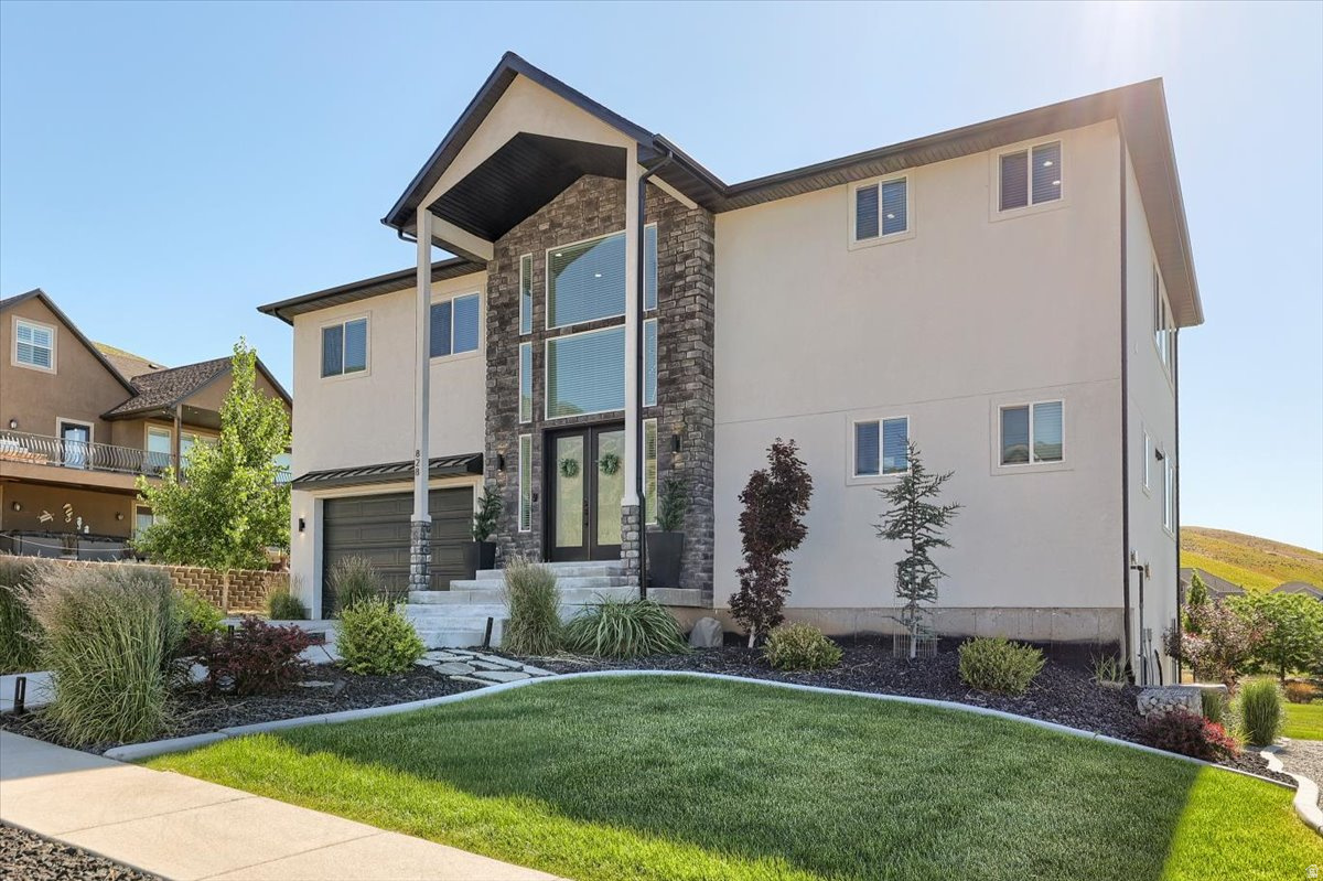 Experience exceptional craftsmanship and luxury living in this stunning custom two-story home with a fully finished walk-out basement. Thoughtfully designed with a clean, modern open-concept floor plan, this residence sits on an expansive 0.54-acre lot offering privacy, space, and incredible outdoor amenities.The resort-style backyard is an entertainer's dream, featuring a sports court, professionally designed landscaping, a secluded and private setting, gazebo, saltwater hot tub, and storage shed. Every detail has been carefully curated to create a relaxing outdoor retreat Inside, you'll find an impressive collection of high-end upgrades throughout. Highlights include a dedicated theater room, custom steel cable railings, a chef's kitchen with premium finishes, a sleek linear fireplace, soaring 10-foot ceilings, oversized doors, safe room and a heated garage with insulated garage doors. Additional features include an on-demand water heater, water softener and filtration system, and numerous custom touches that set this home apart.The luxurious primary suite offers exceptional privacy and breathtaking panoramic valley views, along with a spa-inspired bathroom featuring a massive double shower and relaxing garden tub. This is a rare opportunity to own a truly exceptional home where quality, comfort, and thoughtful design are evident at every turn. A personal tour is the only way to fully appreciate the craftsmanship and attention to detail that make this property so special.