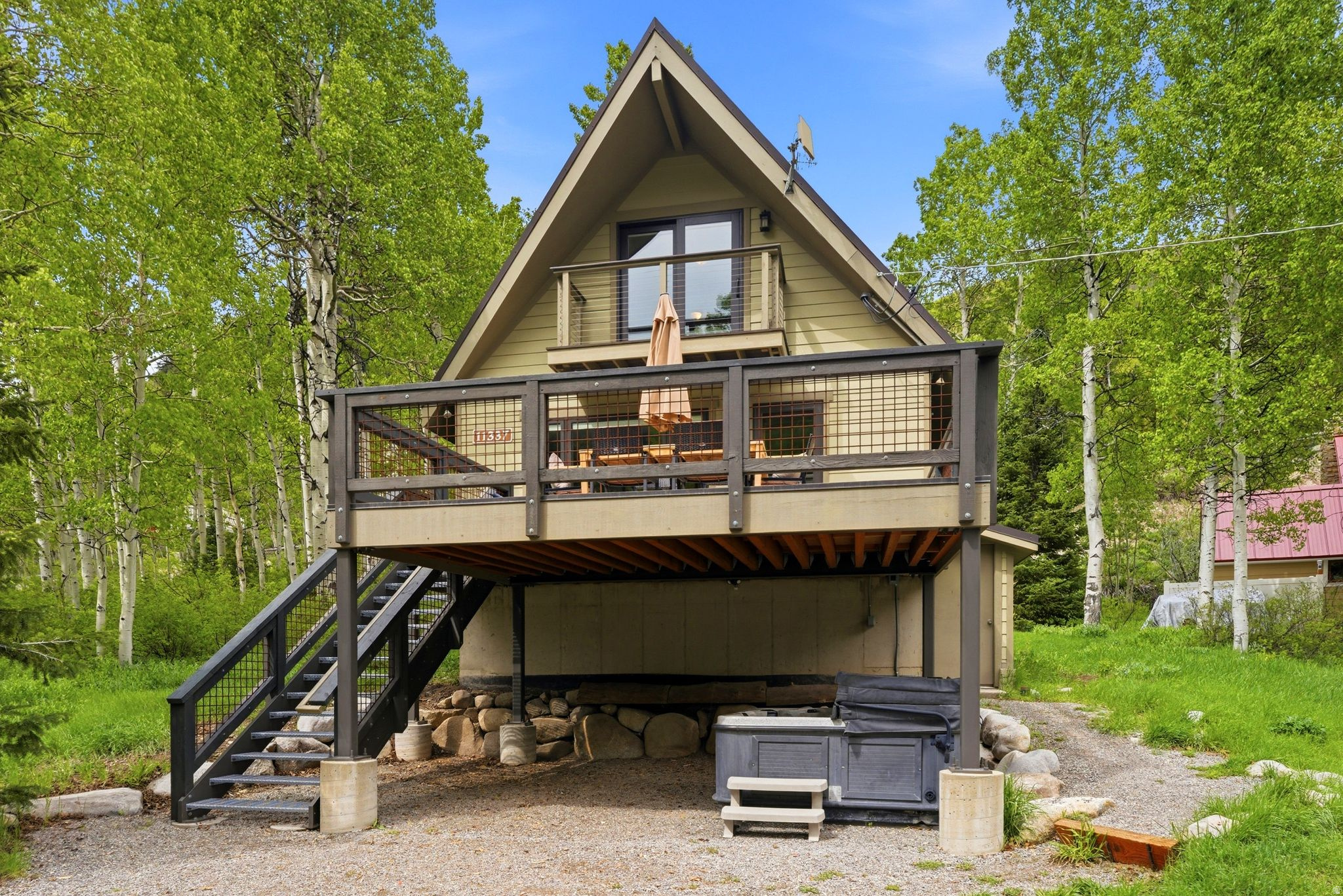 This incredible Big Cottonwood Canyon retreat offers seamless, all-season mountain living with unbeatable access to the backcountry for skiing, hiking, and biking.  A short walk to the ski bus stop and the historic Silver Fork Lodge. The flexibility of .98 acres can allow for expansion of the existing dwelling and garage potential. Designed with a southern orientation, the entire home and its expansive decks are flooded with natural warmth and spectacular, unobstructed views of the Honeycomb Cliffs and surrounding peaks. The open-concept main floor is tailor-made for entertaining and comfortable daily living, combining a spacious living room centered around a cozy wood-burning stove with a modern kitchen that boasts generous workspace, storage, and dining areas. A highly functional mudroom sits right off the entrance for easy gear storage, complemented by an inviting three-quarter bathroom. Upstairs, the home features two comfortable bedrooms, one of which opens directly onto a private observation deck, along with a convenient half bath. Incredible flexibility awaits in the full, unfinished walk-out basement, where dedicated windows and a separate entrance offer the perfect footprint for a future accessory dwelling unit (ADU), extra living quarters, or leave as is for ski tuning, workshop, and immense storage, which is unheard of in the Silver Fork subdivision. Outside, the premium all-season deck is nestled among mature aspens and pines, smartly engineered so you can enjoy the hot tub above while parking your vehicle underneath. Built to withstand rugged canyon winters with minimal upkeep, the structure features durable Hardie plank siding, a metal roof, triple-pane Pella windows, timeless slate flooring, and rich wood trim throughout.