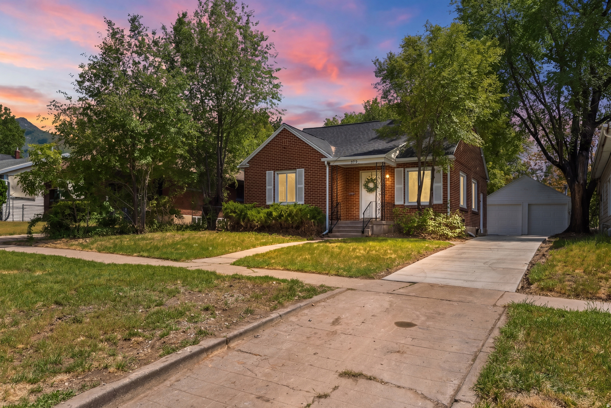 Beautifully remodeled while still preserving its charming brick bungalow character, this updated home features a brand-new roof for added peace of mind. Inside, you'll find all-new kitchen cabinets, updated countertops, a stylish tile backsplash, and stainless-steel appliances. The home also offers new carpet and tile flooring, updated light fixtures, a custom accent wall in the living room, and a functional built-in entry feature that adds both style and character. The bathroom has been fully renovated with a stunning tile surround shower, new vanity, and updated fixtures. Outside, enjoy mature landscaping, an extra-long driveway with plenty of parking space, and a detached 2-car garage. With its classic brick exterior and modern updates throughout, this home perfectly blends timeless bungalow charm with today's finishes.