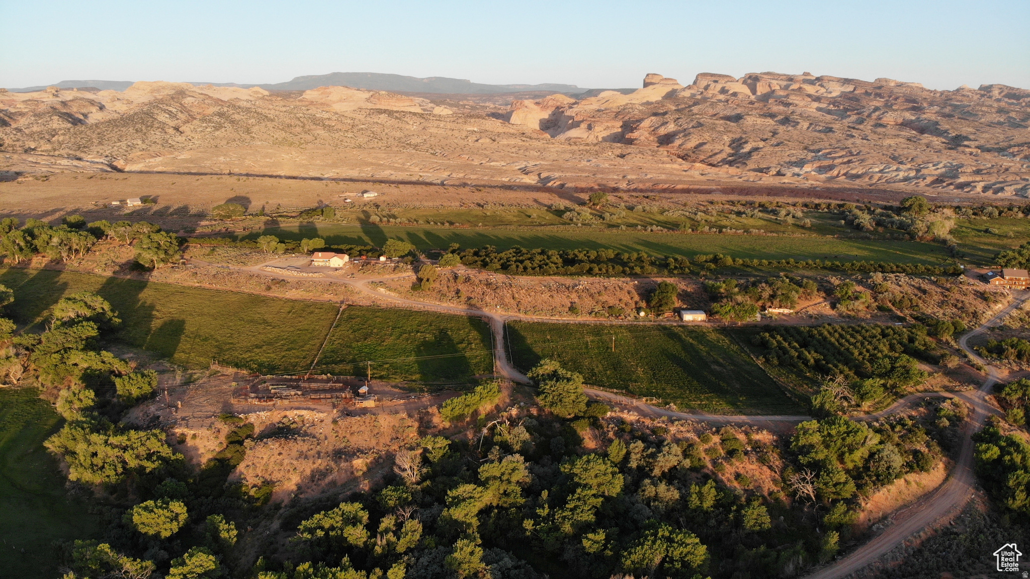 This 226 acre oasis in the middle of the red rocks home to a remarkable homestead that boasts 60 apple trees, 50 apricot, 25 almond with pastures for grazing cattle and cultivating crops. There is a 30 x40' shop w/ power 220 concrete floor and mandoor. Wildlife is a plenty with huge buck, mountain lion, coyotes, and turkeys. Enjoy starry nights and hundred of miles of ATV, horse and hiking trails. Central location and close to the Burr trail, Boulder, Capital Reef, Lake Powell, Torrey, Escalante, Bryce, and the Henry Mountains. Notom has been called "an oasis in the desert". In a harsh, rather bleak landscape, that is an accurate description and it is because there is water. The owner would have a primary water right of 6.3 cfs. on Pleasant Creek from April 1 to November 1. As you look out at fields of alfalfa, green pastures where cows and horses graze, and apricot, almond, and apple trees laden with fruit, you realize that water is truly the "lifeblood" of this arid land. Additionally, farm equipment, including a Swather, bailer, 2 tractors, sprayers, marker mower, blade, gopher getter, harrow, and disc, will be included in the sale.