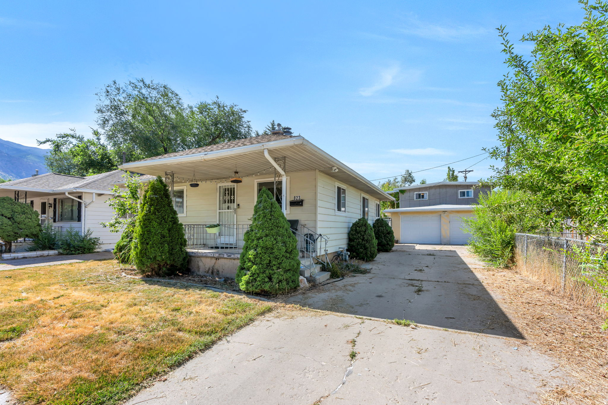 Don't miss this charming home in a PRIME Ogden location! This MOVE IN READY home features fresh interior paint, brand NEW CARPET, updated electrical with new breaker panels in both the home and the detached garage. Tank less water heater was installed in 2020. The real SHOWSTOPPER is the incredible detached garage with room for 3+ vehicles, a dedicated workshop and storage area, plus a heated upstairs BONUS ROOM, the possibilities are ENDLESS! Create the perfect home office, gym, studio, hobby room, or explore the POTENTIAL for future living space or an ADU (Subject to city approval). Inside, you'll find a warm and INVITING living room with a cozy fireplace, spacious bedrooms and plenty of basement storage. Offering COMFORT and functionality with room to make the space your own. Step outside and enjoy the covered back patio and EXPANSIVE backyard, complete with a designated garden area and plenty for space for entertaining summer BBQ's, or simply relaxing outdoors. The front porch is the PERFECT place to start or end your day while enjoying beautiful MOUNTAIN VIEWS! Located within walking distance of Monroe Park, you'll enjoy EASY access to baseball fields, tennis and pickle-ball courts, playgrounds, and wide open green space. This home is one you don't want to miss!   Square footage figures are provided as a courtesy estimate only and were obtained from county records. Buyer is advised to obtain an independent measurement.