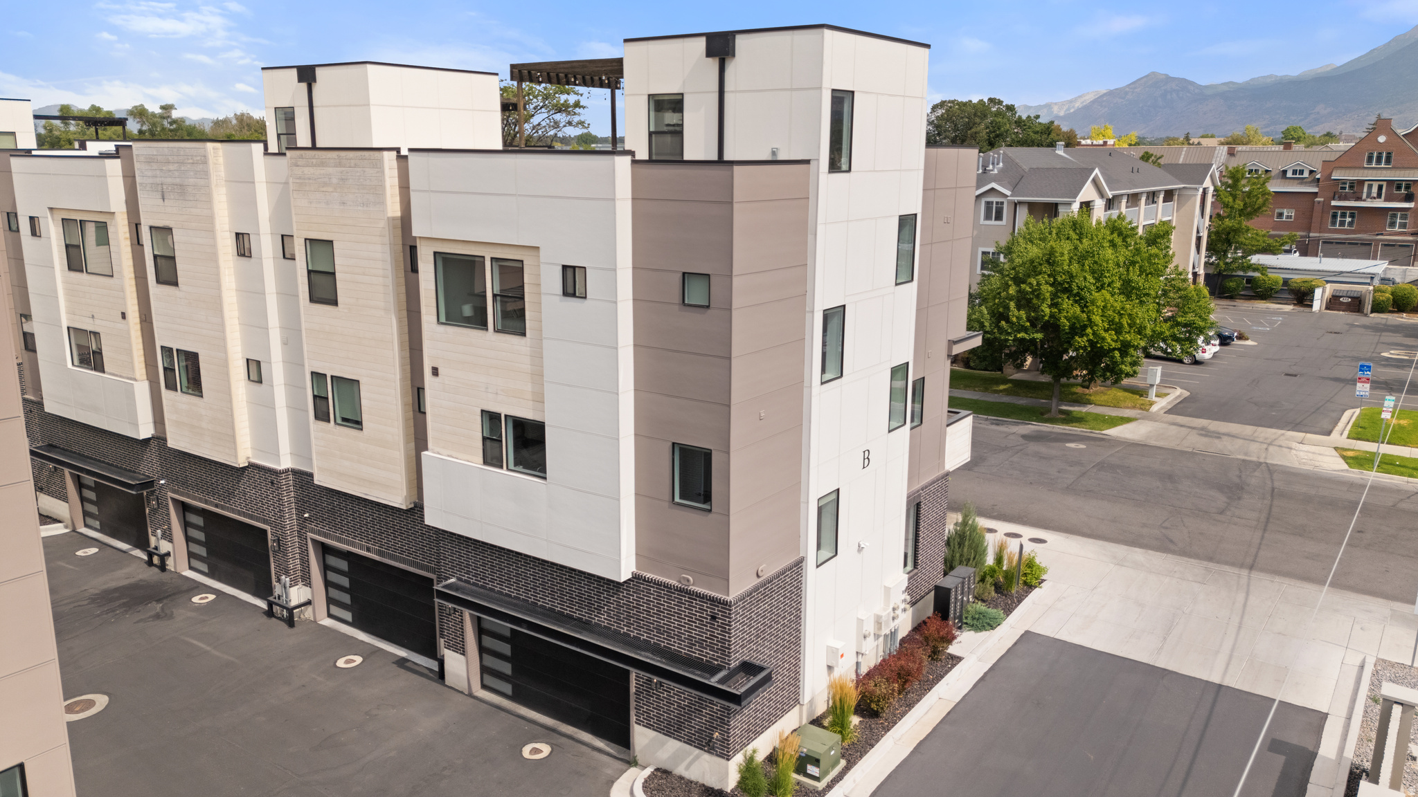 Live the highlife! Great Short Term Rental history! All current nightly rentals & Reservations can/will be transferred to new owner! This is a rarely offered roof-top patio unit that lives large with a natural gas fire pit & hot tub extend living space, providing exceptional year-round views of Mt Timpanogos & "Y" Mountain. Re-live game-day memories as you look out to view Lavell Edwards Stadium through your windows & Roof-top patio! Located in the heart of all Provo City Center amenities. This home has 9' Ceilings, beautiful White Oak plank hardwood flooring, a cozy 36" Gas Fireplace with full brick surround & tasteful architectural details. Exceptional finishes include board shiplap, white oak ceiling beams, craftsman kitchen cabinets w/ brushed gold hardware, large central Island, quartz countertops, tile backsplash & Bosch appliances w/ gas cooktop & double wall ovens. Attention to detail is everywhere. Enjoy a spa quality primary suite, featuring white oak ceiling beams & dreamy oversized, free standing soaking tub, frameless glass step-in shower & spacious walk-in closet. The adjacent 2nd Bedroom also has an en-suite bath. First level bedroom features bunk-beds for lots of fun. Being sold FULLY FURNISHED.
