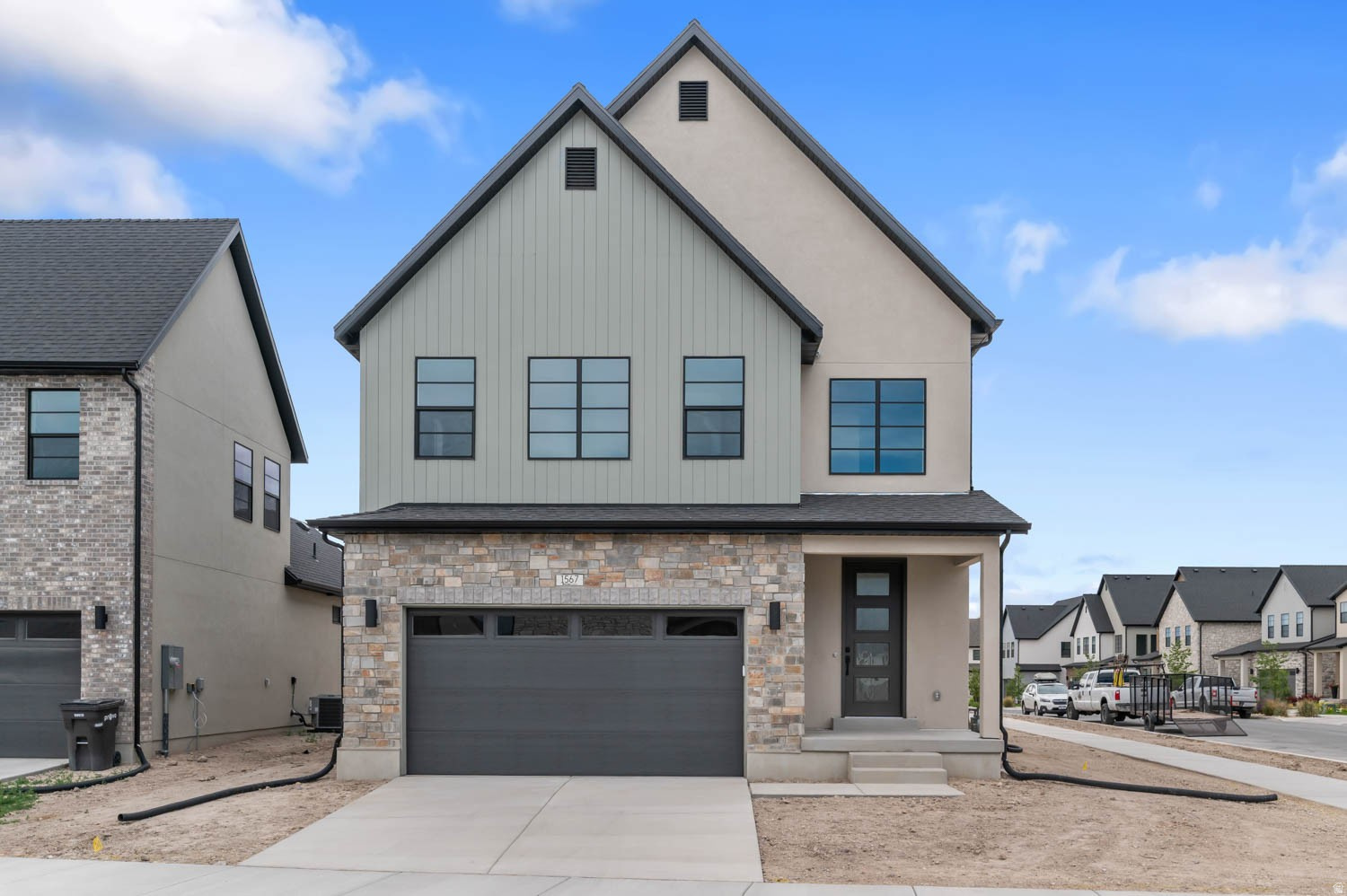 Beautifully designed Sonderborg floor plan in a great Provo community just off the lake! This home features a modern kitchen with Bluff maple cabinetry, quartz countertops, tile backsplash and premium platinum gas appliances. Stylish finishes include laminate hardwood, tile, and carpet flooring, recessed can lighting, and elegant two-tone paint throughout. Enjoy cozy evenings by the gas log fireplace and appreciate thoughtful details like Christmas light outlets, energy-efficient features, and a tankless water heater. The staircase is accented with modern metal railing, while craftsman-style baseboards and casing add timeless character. The owner's bathroom offers luxurious quartz surrounds, complemented by sleek black matte hardware, creating a refined blend of comfort, style, and modern farmhouse elegance throughout the home.