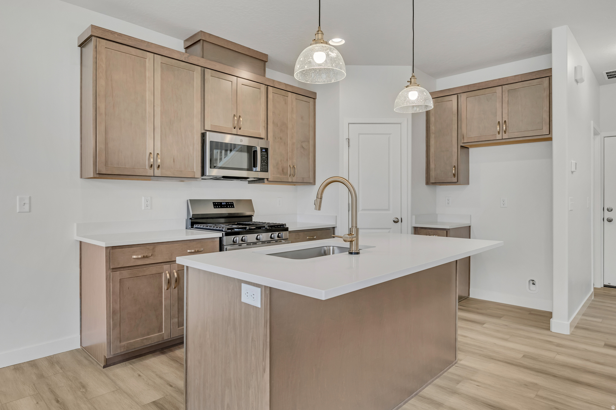 Experience modern comfort and style with the Buchanan townhome in the sought-after Harmony Place community in Salem. The kitchen is a chef's delight, featuring premium stainless steel gas appliances, quartz countertops, 42" upper cabinets, and stylish pendant lighting over the island. The spacious primary suite offers a dual-sink vanity with quartz countertop, a shower/tub combo, and a private door at the bath. Bath 2 is equally well-appointed with an undermount sink, quartz countertop, and a shower/tub combo, while the powder room features a classic pedestal sink. Enjoy 9' ceilings on the main floor, elegant railing on both levels, pre-plumbing for a future water softener, and an 8' garage door with keypad access for added convenience. Located in a vibrant community with nearby parks, walking trails, and planned amenities, the Buchanan townhome offers both style and function in an ideal Salem location.