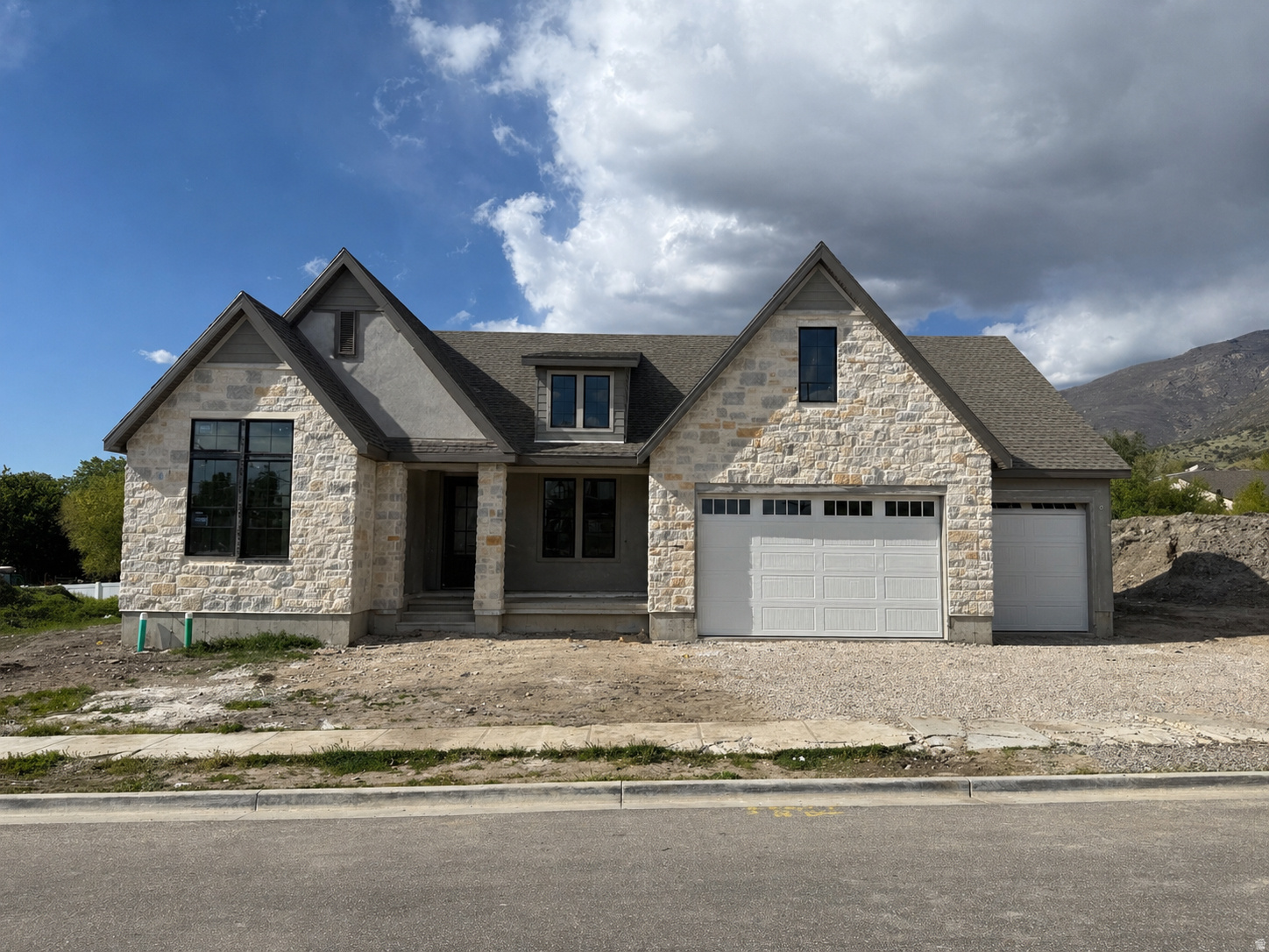 LOT#123A Summerhill Lane. This 'Treble XL' floor plan by Symphony Homes is currently under construction and due to be completed by August, is very popular, especially with the new "European Romantic" elevation, and offers thoughtfully designed living space that blends everyday comfort with genuine luxury at every turn. Price includes full yard landscaping. At the heart of the home will be a chef's kitchen that will take your breath away, featuring a 48" dual-fuel professional range, a custom decorative hood, panel-ready integrated refrigerator and freezer columns, a microwave drawer tucked into the island, an undercounter ice maker, and an expansive butler's pantry designed for serious entertaining. The family room will be nothing short of spectacular, with soaring stain-grade knotty alder ceiling beams, a stunning floor-to-ceiling natural stone fireplace with a custom mantel, and rich custom millwork details throughout. The primary suite will be your personal retreat, a tray ceiling with crown molding, a spa-worthy bath complete with a large garden tub, ceiling-height tile surround, oversized shower with built-in bench and niche, dual vanities, and a custom walk-in wardrobe. The  basement will deliver incredible versatility with a spacious game room, cold cellar, a beautifully appointed wet bar, and a finished storage room. Car enthusiasts and hobbyists will love the 3-car garage, including a rare 43' deep third bay that offers storage and flexibility few homes can match. Covered patio. Only 20 minutes to downtown SLC, and conveniently located to several shopping areas. Built by renowned local builder Symphony Homes with the craftsmanship and attention to detail they're celebrated for. Opportunities like this don't come around often. Don't Miss It!