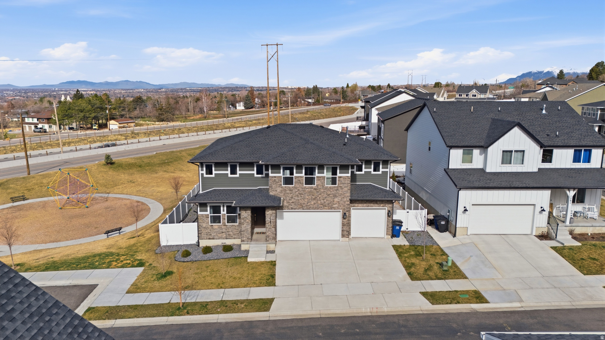 Beautiful East Bench Kaysville home featuring 4 bedrooms, 3 full bathrooms, and 4,445 sq ft with a large unfinished basement providing room to grow. The main level features a formal living room/office off the entry, a bedroom and full bathroom, and a large open-concept living area with a cozy gas fireplace, vaulted ceilings, and floor-to-ceiling windows that fill the space with natural light. The kitchen is designed for entertaining with a 10-ft quartz island, gas cooktop with vented hood, Electrolux double wall ovens, butler's pantry, and abundant cabinet space. Upstairs includes a spacious loft, laundry room, and three bedrooms with two bathrooms, including a primary suite featuring a walk-in closet, linen closet, dual sinks, and an extra-large shower. All appliances included. Additional features include two furnaces, two A/C units with zoned climate control, smart thermostats, Flo by Moen smart water shutoff, myQ garage system, video doorbell, and radon mitigation system. This Lennar Teton floor plan sits on a 0.20-acre corner lot next to the park with a 3-car garage. The backyard is fully fenced and xeriscaped with over 1,600 sq ft of concrete patio space, perfect for outdoor entertaining and enjoying the surrounding views. Located in the Talbot Heights subdivision with convenient access to Hwy 89, I-15, and nearby hiking and biking trails.