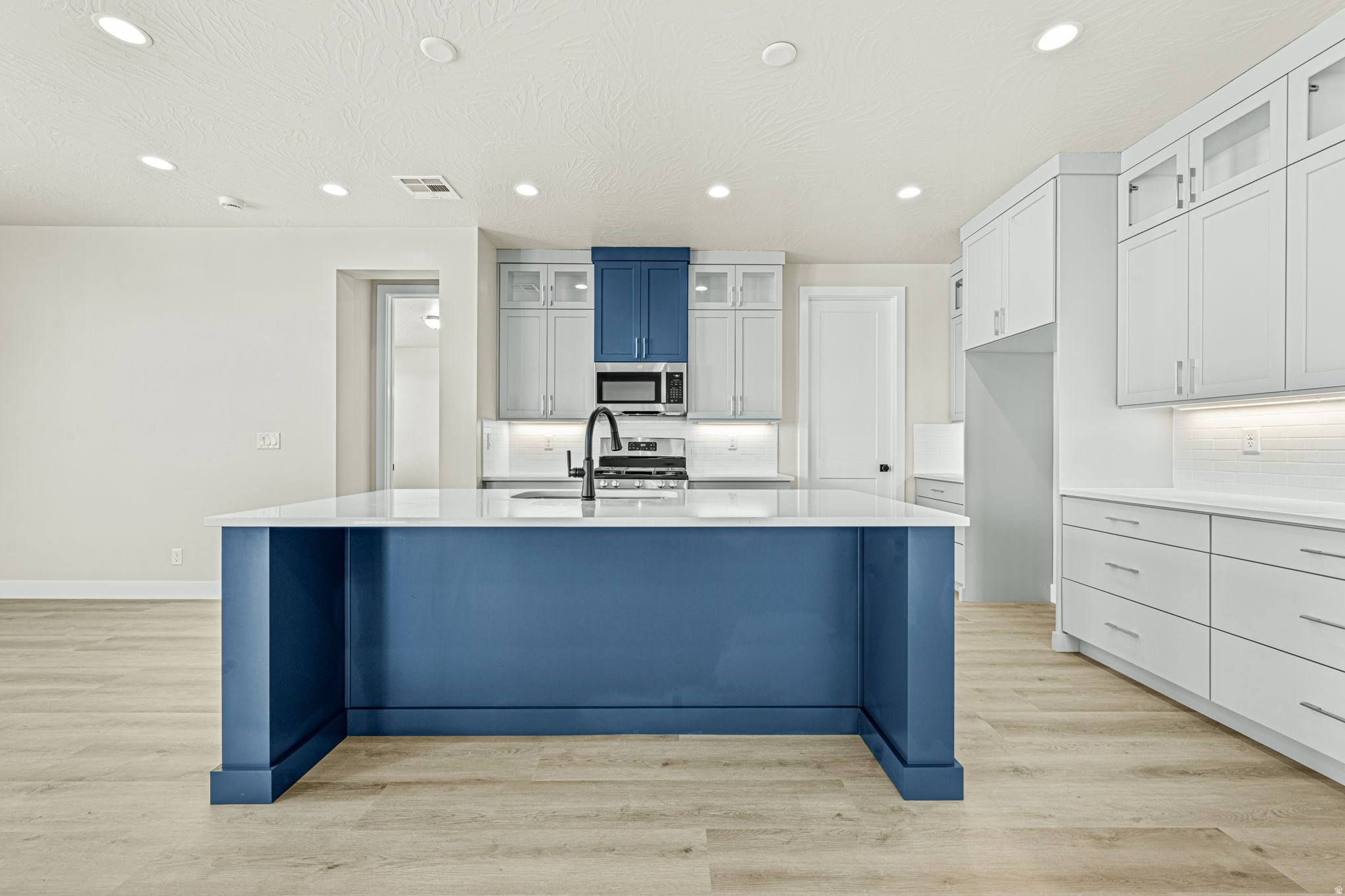 Step into the Highland, a beautifully designed 4-bedroom, 3-bathroom home offering an expansive 2,200 square feet of thoughtfully crafted living space. The kitchen, a true focal point of the home, includes optional gourmet upgrades. The primary suite serves as a serene retreat, featuring an elegant ensuite bathroom and two spacious walk-in closets for all your storage needs. The convenient 2-car garage offers the option for a third bay, ideal for recreational vehicles or additional storage. Enjoy the vibrant lifestyle this community offers, complete with resort-style amenities like a year round pool and spa, as well as scenic trails for outdoor adventures.
