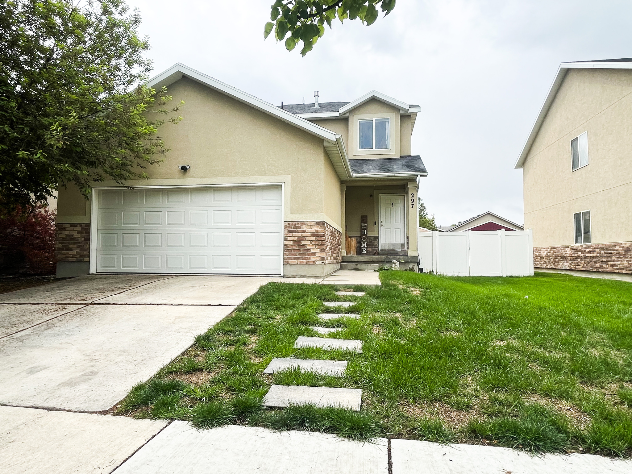 Welcome to this light-filled home featuring an open layout that seamlessly connects the living, dining, and kitchen areas. Enjoy beautiful views of the Wasatch Mountains as you approach from the street in front. The main floor boasts recently installed engineered hardwood floors (30-year warranty, refinished-ready) and elegant hardwood stairs leading to the upper level. Adjacent to the dining area and kitchen is a convenient seated bar, ideal for casual meals or entertaining. A separate main-floor laundry room offers extra space for Costco-sized storage.  All paint throughout the home has been updated within the last few years by the owner, who has lovingly maintained the property for the past four years. Upstairs, you'll find two bedrooms that share a full bath, along with a master suite featuring its own full bath. All upstairs rooms include dimmable lighting for customizable comfort. The bright, finished basement offers an extra-large bedroom-perfect as an office, guest room, craft space, or any combination-plus a full bathroom. Recent upgrades include recessed, dimmable lighting for a movie-night ambiance and plenty of storage throughout. Enjoy the fully fenced backyard, while the front yard features a sprinkler system and a welcoming, nicely sized porch. The garage is drywalled and painted for a polished look. This home is within walking distance to two parks-one just five houses away, and another a block and a half away-perfect for outdoor activities. Move-in ready with modern upgrades, flexible spaces and an unbeatable location!