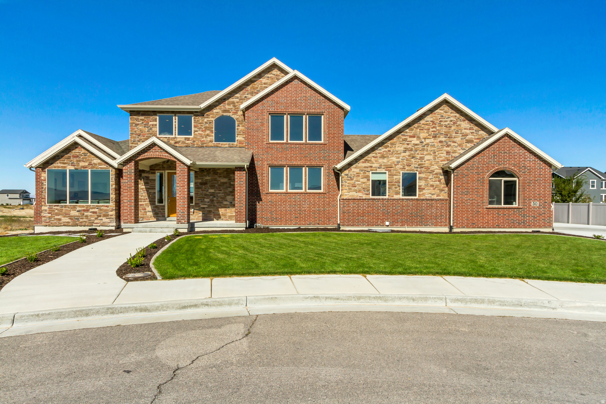 $50,000 PRICE REDUCTION!!!  SELLER IS ALSO OFFERING $8,000 toward CLOSING COSTS when you use our preferred lender ...****...   NEWER 2021 CUL-DE-SAC HOME, located in an exclusive GATED COMMUNITY with PRIVATE LAKE ACCESS!!  This HIGH-END RESIDENCE features SOARING CEILINGS, OPEN LAYOUT, BIG WINDOWS bringing in natural light, and much more to love!!  Besides the 6 bedrooms, there is also a dedicated OFFICE ROOM/LIBRARY on the main level, perfect for working from home.  The basement has its own SEPARATE WALKOUT ENTRANCE and has already been plumbed for a SECOND KITCHEN or MOTHER IN LAW APARTMENT/ADU setup.  There are also 2 SEPARATE LAUNDRY ROOMS, one on the main level and one downstairs.  The huge backyard is perfect for friends and family get togethers.  The spacious 3 CAR GARAGE and RV PARKING provide plenty of parking space for all your vehicles, recreational toys, and guests.  LOCATION is unbeatable!! Enjoy fun WATER ACTIVITIES such as kayaking and paddle-boarding. You are also within minutes to schools, grocery stores, shopping, and the Stansbury Park Golf Course. Plus, only about 30 minutes from Salt Lake City.   This is the home you've been looking for - come see it today!   Information and measurements are provided as a courtesy; buyers are advised to see the home in person, obtain their own measurements, and verify all information.