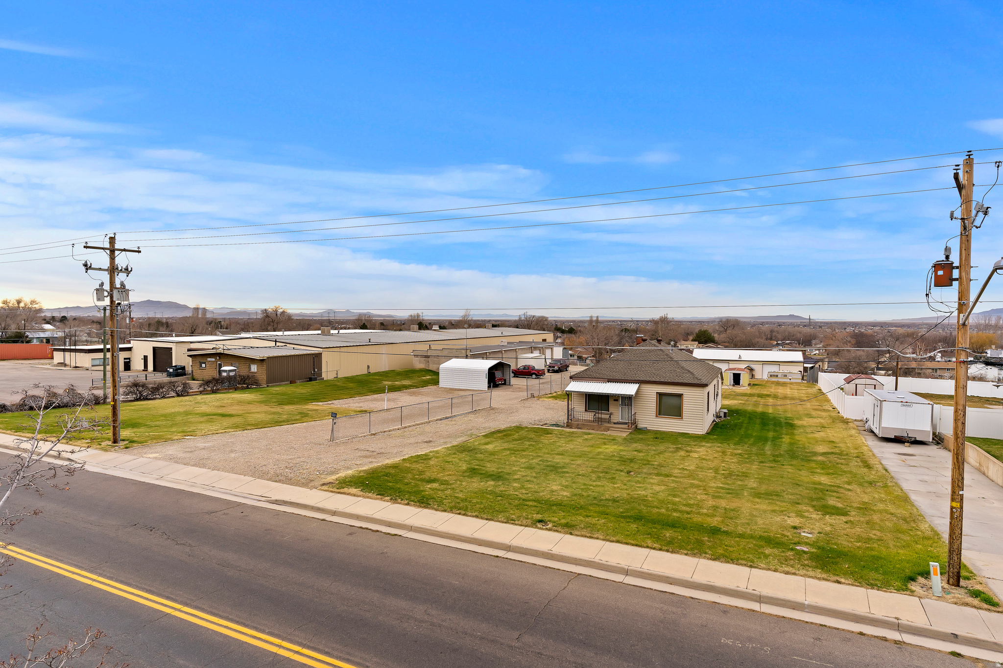Exceptional commercial property situated on 1.94 acres in Roy. This unique offering includes two commercial buildings as well as a residential home, ideal for owner occupancy or as a rental investment. The first commercial building offers 3,600 square feet, along with an additional 1,102 square feet of unheated storage, and 3 10x10 overhead doors. The second building provides 3,200 square feet. Both buildings are equipped with three-phase power, and 2 12x12 overhead doors. The residence features 1,718 square feet of living space, including two bedrooms, one bathroom, and a loft area. This is a rare opportunity to acquire a versatile property with both commercial and residential components, along with everything needed to pick up the business. Includes Parcel #09-066-0007, #09-065-0014, #09-065-0023, & #09-065-0025.