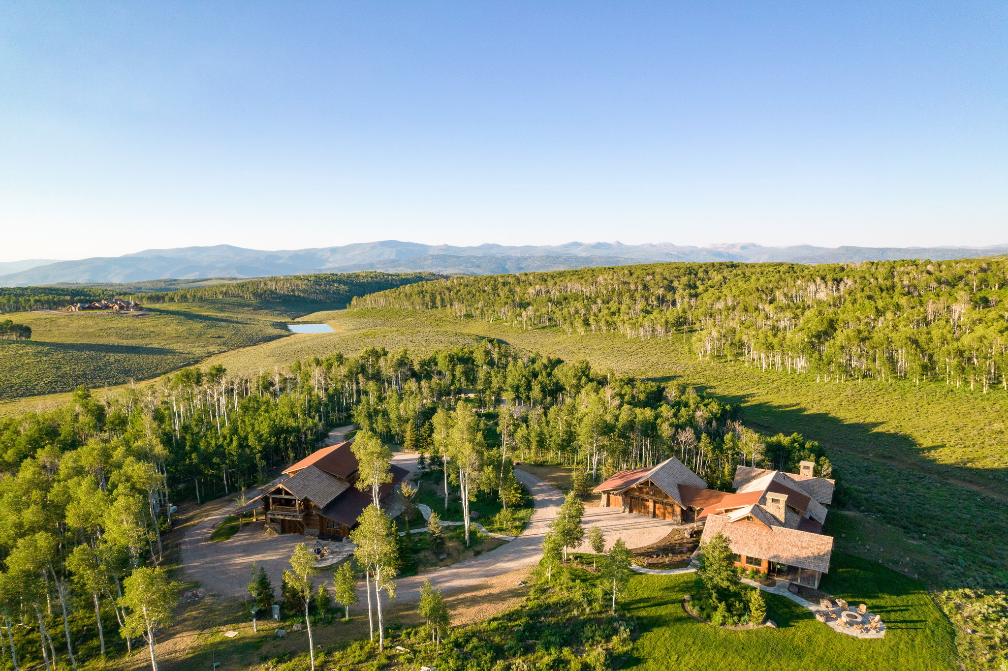 Welcome to Aspenrise. A secluded mountain sanctuary where architectural excellence meets the raw elegance of the high alpine landscape.  Tucked within a gated forest enclave, Aspenrise is surrounded by whispering groves of aspen trees, offering rare privacy that feels both serene and accessible. Conceived by the award-winning Pearson Design Group (Bozeman, MT) and meticulously built by Magleby Construction in 2020, this extraordinary estate currently includes a finely crafted guest cabin and a fully appointed barn, together offering four bedrooms and four and a half bathrooms across both structures.  Aspenrise is thoughtfully positioned on land that allows for up to three distinct structures: a main residence, a guest home, and a barn. With the guest home and barn already completed to an exceptional standard, a future owner has the opportunity to design and build a legacy main home, completing the vision for a fully realized mountain compound.  Inside, every detail speaks the quiet, confident language of authenticity. Hand-selected reclaimed wood, locally sourced stonework, and period-accurate fixtures give each space depth and character. The great room offers soaring beams and panoramic alpine views. The kitchen and bathrooms are timeless in their materiality and execution. The barn, equal parts functional and refined, offers flexible space for hosting, working, or unwinding in style.  Wolf Creek Ranch offers an unmatched lifestyle - a private, gated sanctuary with 60 miles of scenic trails for hiking, horseback riding, fishing, and winter adventures. Do not just dream about mountain living - experience it.