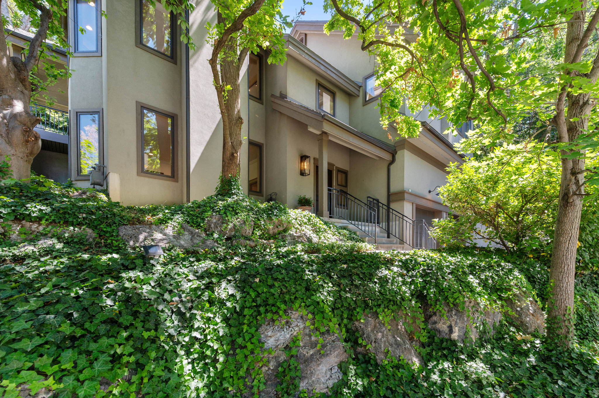 This fully renovated home in historic Gilmer Park is just blocks from 9th & 9th, but feels like a mountain retreat. Mature trees surround the property, giving it a quiet, private setting. Vaulted ceilings with exposed wood trusses run through the main living space, above new oak wood floors. Solid wood doors, wood windows and custom trim carry through the home. The kitchen is custom walnut with a gas cooktop, a built-in JennAir refrigerator, generous counter space, and a separate prep area. A wet bar on the main floor adds extra flexibility for entertaining. Two gas fireplaces and 3-zone radiant heated floors warm the home in winter, with forced-air A/C for summer, and solar panels keep electric bills low. The primary suite is spacious, with a large walk in closet, wool carpeting, power blackout shades, and direct access to a covered patio. In back, a shaded deck sits beneath a canopy of trees, perfect for relaxing or outdoor cooking. The home also includes an attached two car garage and an extra 300 square feet of storage not included in the listed square footage. Owner/Agent