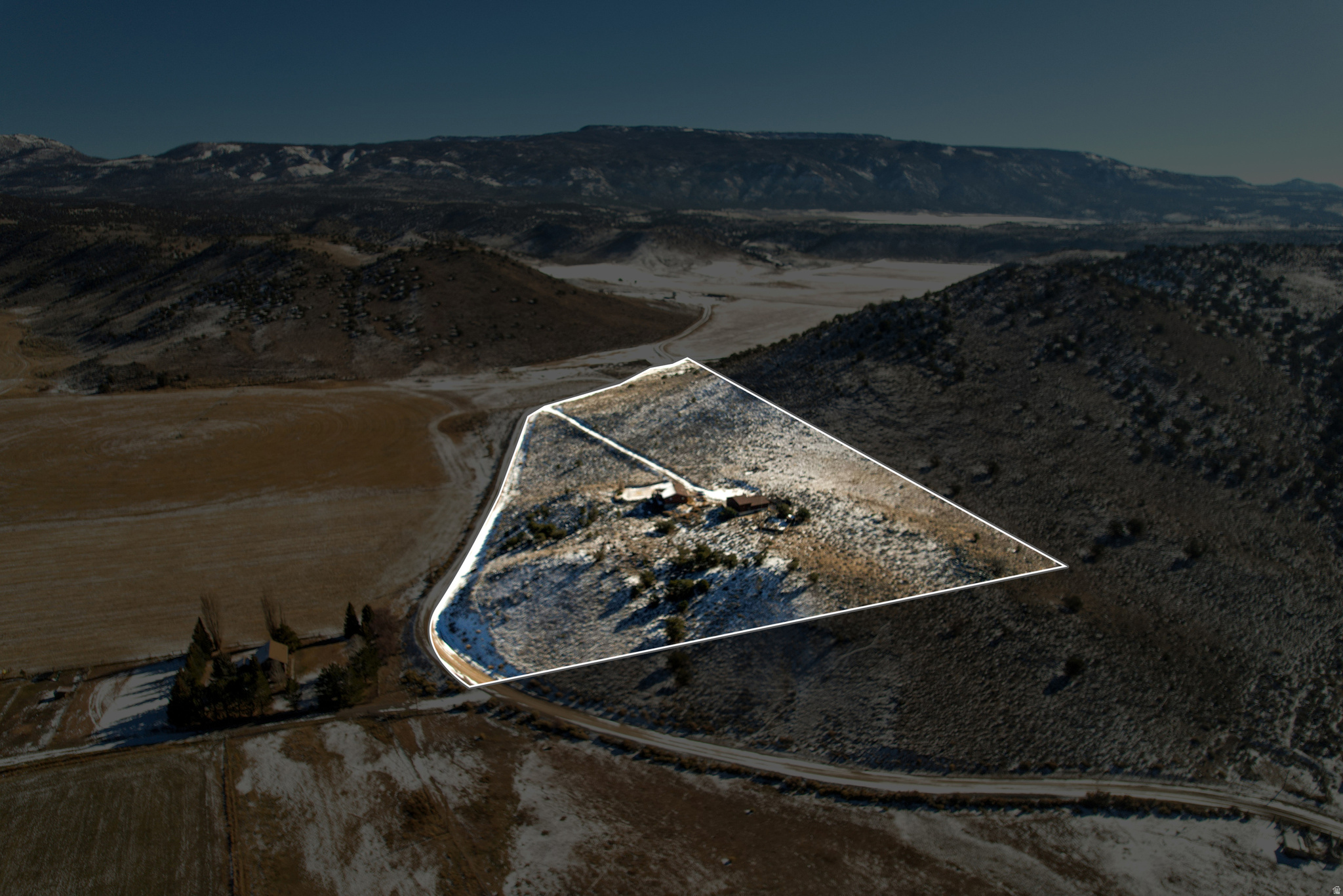 Discover an unmatched combination of privacy, open-concept luxury, and utility on this breathtaking 13.22-acre estate in Fremont. Positioned perfectly to capture unobstructed, panoramic views of Wayne County's legendary mountain and valley landscapes, this property is the ultimate retreat for those who value both wide-open spaces and top-tier workshop capabilities. The 2,788-square-foot main residence welcomes you with a bright, flowing open floor plan designed to seamlessly pull the dramatic outdoor vistas into your everyday living areas. At the heart of the home is a spacious gathering area anchored by a cozy fireplace-perfect for unwinding after a day out on the land. With 3 comfortable bedrooms and 2 full bathrooms, the interior offers a warm, functional sanctuary that opens out to a large, expansive yard ideal for outdoor entertaining, pets, or landscaping. Steps away from the home sits the ultimate crown jewel: a massive, detached 6-car garage and shop. This rare, oversized outbuilding provides unparalleled storage for a truck fleet, boats, ATVs, and snowmobiles, or functions as a dream workspace completely isolated from the main living quarters. Surrounded by more than 13 private acres to protect your peace and views, this property serves as a world-class basecamp. Explore the high-alpine lakes and pine forests of Fishlake National Forest just to your north, or take a scenic 30-minute drive south into the towering red cliffs of Capitol Reef National Park.