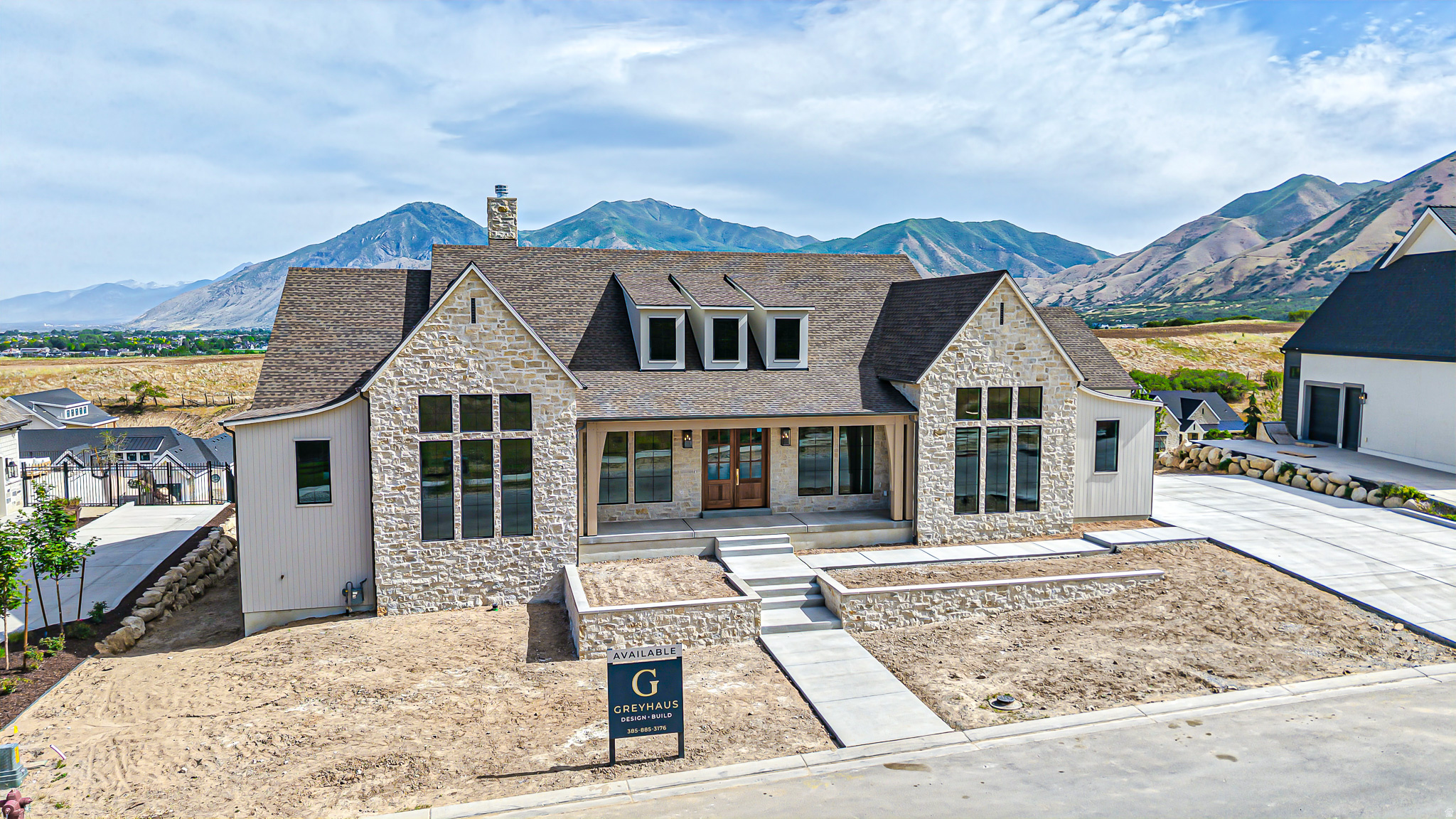 Exceptional luxury new construction in one of Mapleton's most prestigious neighborhoods. Situated on a premier view lot with a rare usable backyard, this 6,676 sq ft walkout rambler showcases breathtaking views from nearly every room through expansive floor-to-ceiling windows. Featuring 5 bedrooms, 4 bathrooms, a dedicated office, formal dining room, butler's pantry, basement laundry, and an oversized vaulted 4-car garage with suspended garage below. The designer kitchen is equipped with a premium appliance package including a 48" gas cooktop with griddle, vented hood, and oversized refrigerator/freezer combo. Luxury finishes throughout include white oak cabinetry, engineered hardwood floors, Taj Mahal quartzite, Calacatta Viola marble, custom beam work, upgraded soft-close cabinetry, designer tile, natural stone accents, and two fireplaces. The impressive primary suite offers panoramic views, a freestanding soaking tub, dual shower, makeup vanity, and expansive custom closet. The walkout basement features 10' ceilings and unfinished flex space pre-planned for a gym, golf simulator, theater room, and future 5th bathroom. Enjoy outdoor living from the covered deck overlooking all of Utah Valley or the covered patio below. Dual street frontage with available utilities offers future flexibility in the backyard. A rare opportunity to own a thoughtfully designed luxury home combining exceptional craftsmanship, premier views, and endless potential.
