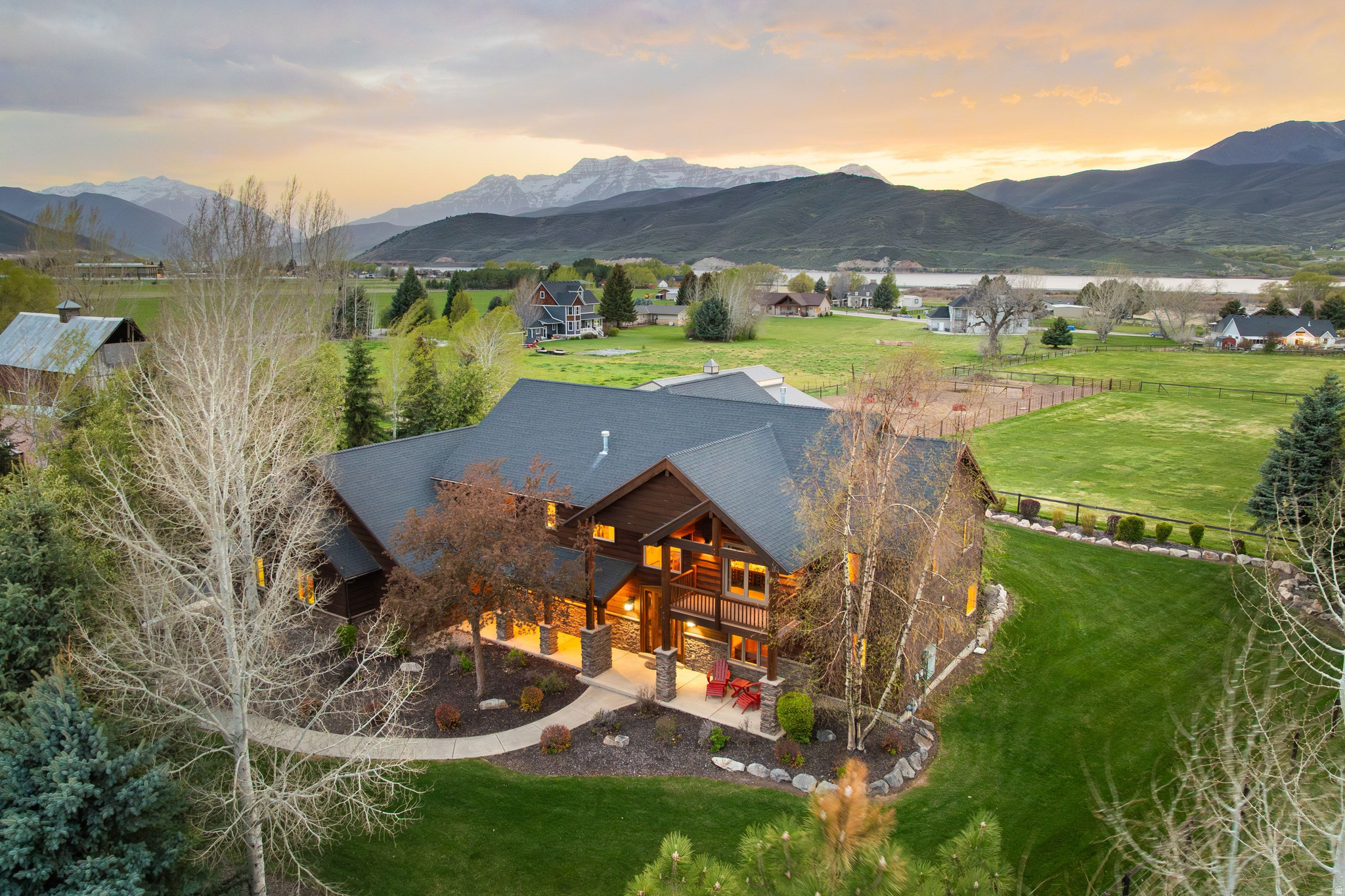 There's a certain stillness here that's hard to find, and even harder to leave.  Set on 4.49 private acres beneath the ever-changing face of Mount Timpanogos, this is more than a property, it's a place where mornings begin with soft light spilling across open pastures and evenings settle into quiet, uninterrupted views of the mountains and across Soldier Hollow. Life unfolds a little differently here slower, more intentional, more connected.  Designed with both lifestyle and land in mind, the property invites you outside as much as it draws you in. Horses move freely across two pastures and paddocks, while the arena offers space to ride, train, or simply take in the rhythm of the surroundings. A thoughtfully built 4-stall barn anchors the equestrian setting, while mature landscaping creates a sense of privacy that feels both rare and grounding.  Inside, the home mirrors the landscape, warm, open, and oriented toward what matters most. Expansive windows frame the mountains and pastures like living artwork, while the main living spaces, kitchen, dining, great room, and primary suite are positioned to capture it all. Rich hickory floors, vaulted ceilings, and beautifully crafted wood finishes bring a sense of quiet luxury, while the kitchen equipped with Thermador appliances and a generous walk-in pantry becomes a natural gathering place for family and friends.  Despite its sense of seclusion, the property is just minutes from the charm of Midway, with its local shops and dining. World-class skiing at Deer Valley Resort, Park City Mountain, and Sundance Resort is within easy reach, while warmer months invite time at Deer Creek Reservoir, nearby blue-ribbon fishing waters, and miles of scenic trails. With five golf courses close by, the lifestyle naturally extends through every season. Convenient access to Heber Valley Airport and Salt Lake City International Airport ensures you're well connected, yet still a world apart.