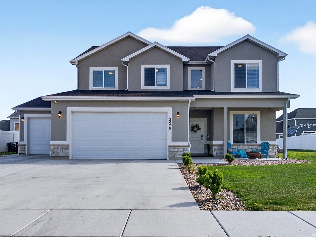 Need garage space? This 2023-built Farr West home delivers with an oversized extra-tall, extra-deep garage, a wide driveway, and dedicated side parking that can be hard to find.  Offering 4 bedrooms plus a dedicated office, 2.5 bathrooms, and a second family room, this two-story home combines flexible living space with practical functionality. The main level features a private office with glass French doors, a mudroom, half bath, and an open-concept kitchen complete with a gas range, large island, walk-in pantry, and seamless flow into the living room with a cozy gas fireplace.  Upstairs, the spacious primary suite includes a walk-in closet and ensuite bath with a glass-enclosed shower. Three additional bedrooms, a full bathroom, laundry room, and an additional family room provide plenty of room for everyday living.  Situated on a fully irrigated 0.27-acre lot in a completed neighborhood with no surrounding construction, this home is move-in ready inside and out. Additional features include fiber optic wiring for high-speed internet and a dedicated switch for exterior roofline lighting.  Enjoy beautiful views of Ben Lomond Peak and convenient access to 2700 North, Hill Air Force Base, and the growing retail corridor, including the new Target development nearby. If you've been searching for a newer home with exceptional garage space, parking, and flexible living areas, this one deserves a closer look.