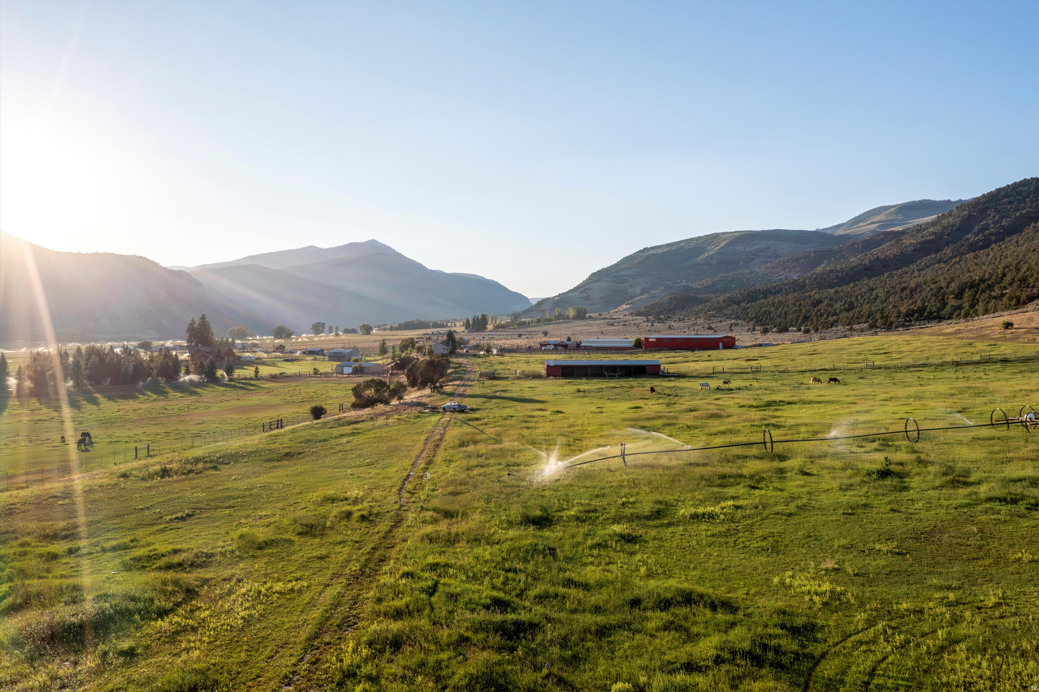 The property is currently being subdivided into two parcels, giving buyers the option to purchase the home with the outbuildings, barn, and indoor arena on 10 acres, or a separate 31-acre parcel that includes 20 water shares.Postcard-perfect views from every angle set the stage for this hidden equestrian paradise, nestled at the end of a quiet dead-end road in Hanna, Utah, just one hour from Heber. Spanning 41.32 acres, this turnkey horse property is built for both function and serenity. With 30 valuable water shares, the land is well-equipped to support irrigated pasture, hay production, and all your livestock and equine needs-providing both abundance and sustainability for ranch life. The property borders open land with access to hundreds of miles of trails-ride straight from your barn into vast, scenic country with no need to trailer out. Equestrian facilities include a 120' x 40' all-metal stall barn with eight stalls, a 150' x 80' indoor riding arena for year-round training, and an outdoor arena for riding under open skies. A massive 80' x 40' open-sided hay barn provides generous storage, supported by two additional 60' x 25' open- sided pole barns, a 60' x 25' machine shed, a 12' x 48' lean-to shelter, a woodshed, and a charming chicken coop. The land is a peaceful blend of open pasture and native growth, with wild herbs thriving across the property-a place where nature whispers and horses thrive. The existing home offers comfort and practicality with 4 bedrooms and 2 bathrooms, a spacious layout that includes two family rooms anchored by a wood-burning stove. A large pantry, abundant cupboards, and generous closet space throughout make daily living effortless. Whether you live in the current home or build your dream retreat overlooking the valley, this is a rare opportunity to settle into a lifestyle rooted in peace, purpose, and the freedom of wide-open spaces. Property may be subdividable in 6 acre pieces , additional due diligence would be needed. Square footage figures and boundary lines are